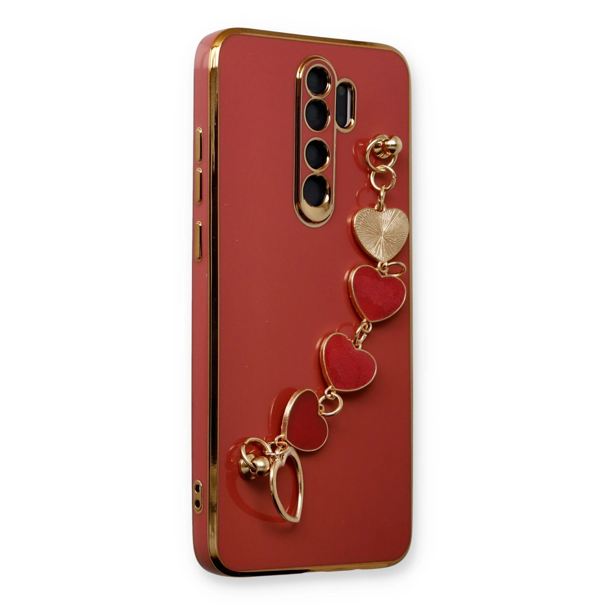 Altın kenarlı kırmızı telefon kılıfı ve kalp şeklinde takı.