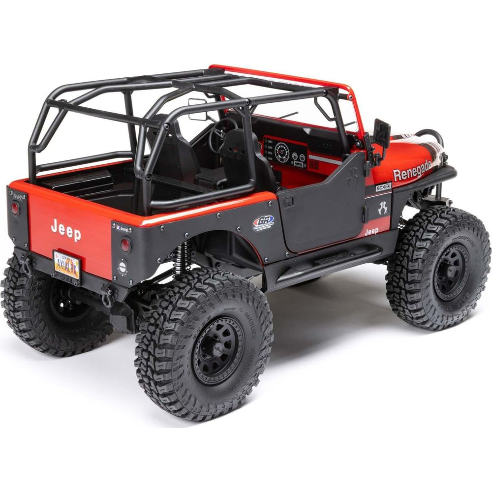 Un Jeep rouge avec arceau de sécurité noir et gros pneus, sur fond blanc.