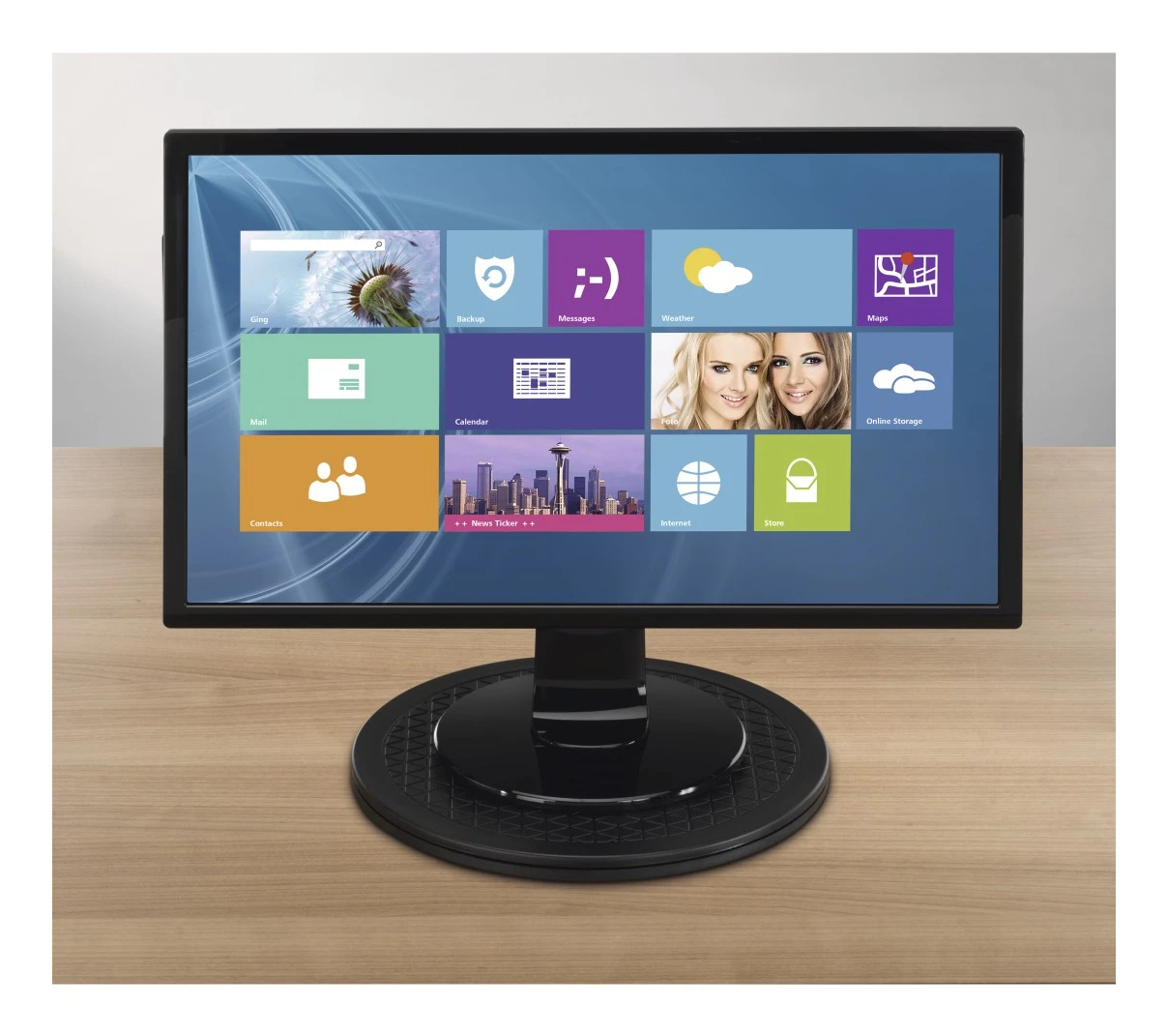Ein schwarzer Computermonitor zeigt ein Windows-Startmenü mit bunten Kacheln.