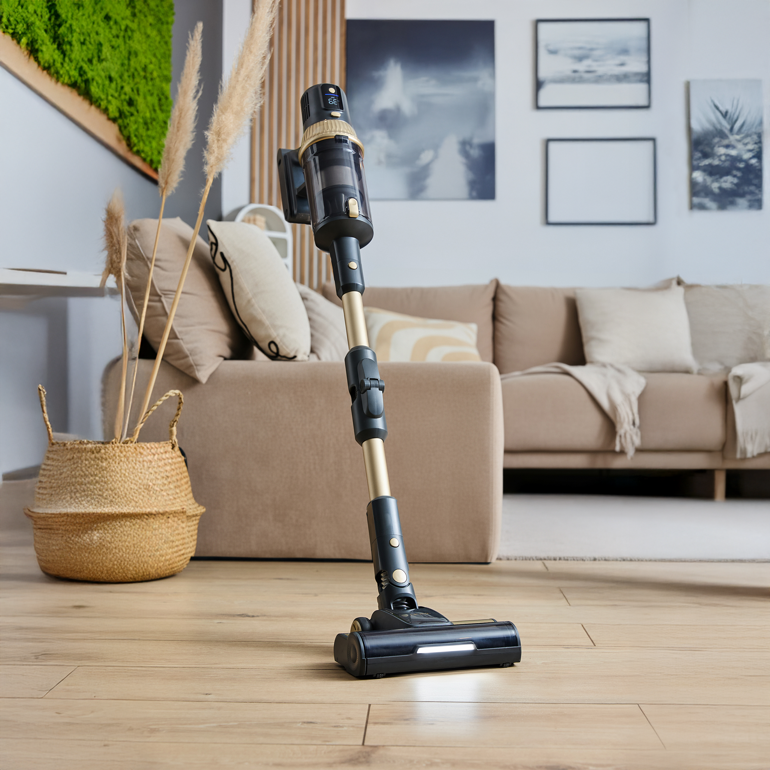 Czarno-złoty odkurzacz akumulatorowy stoi na drewnianej podłodze przed kanapą.