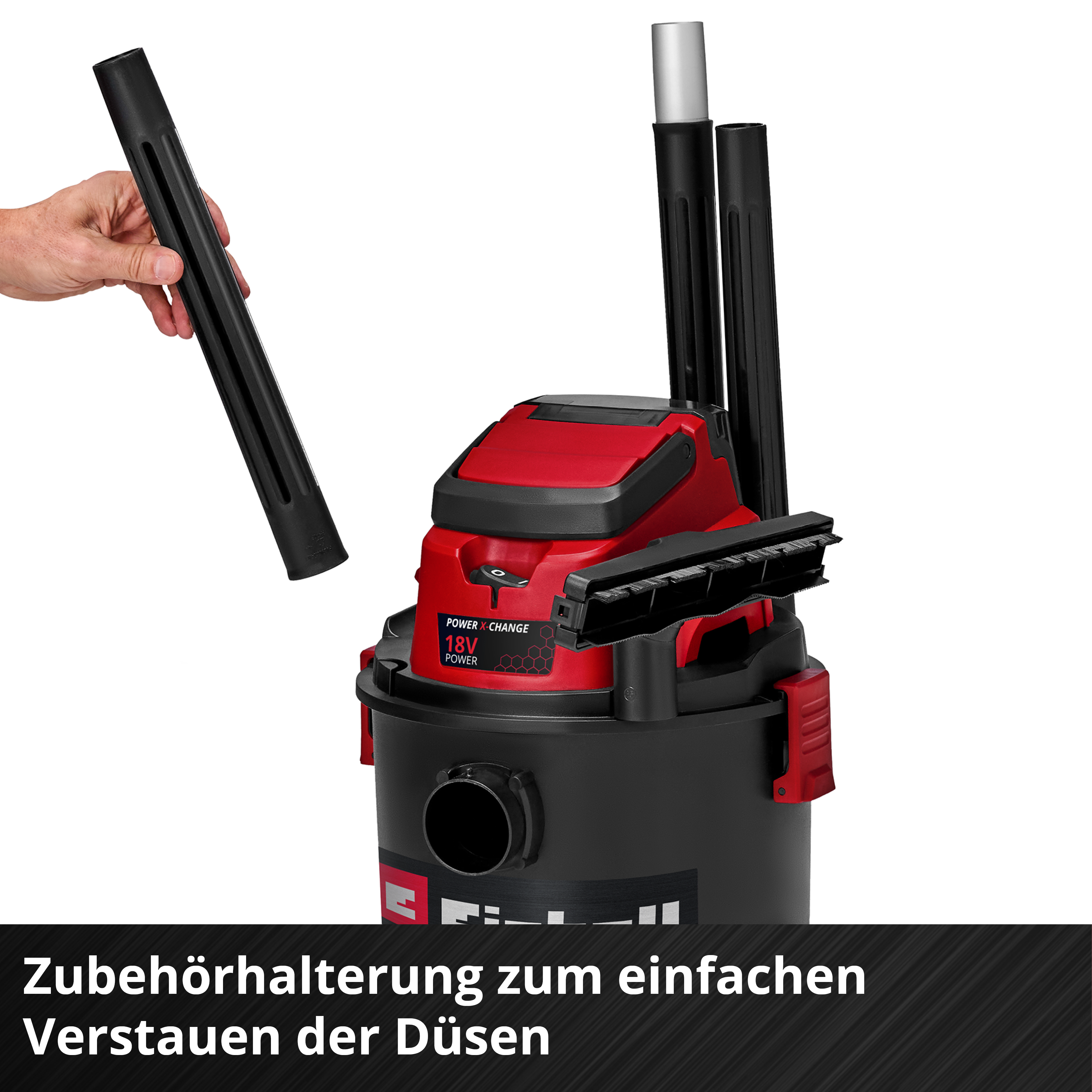 Ein Handgriff hält ein schwarzes Rohr über einem roten und schwarzen Staubsauger.