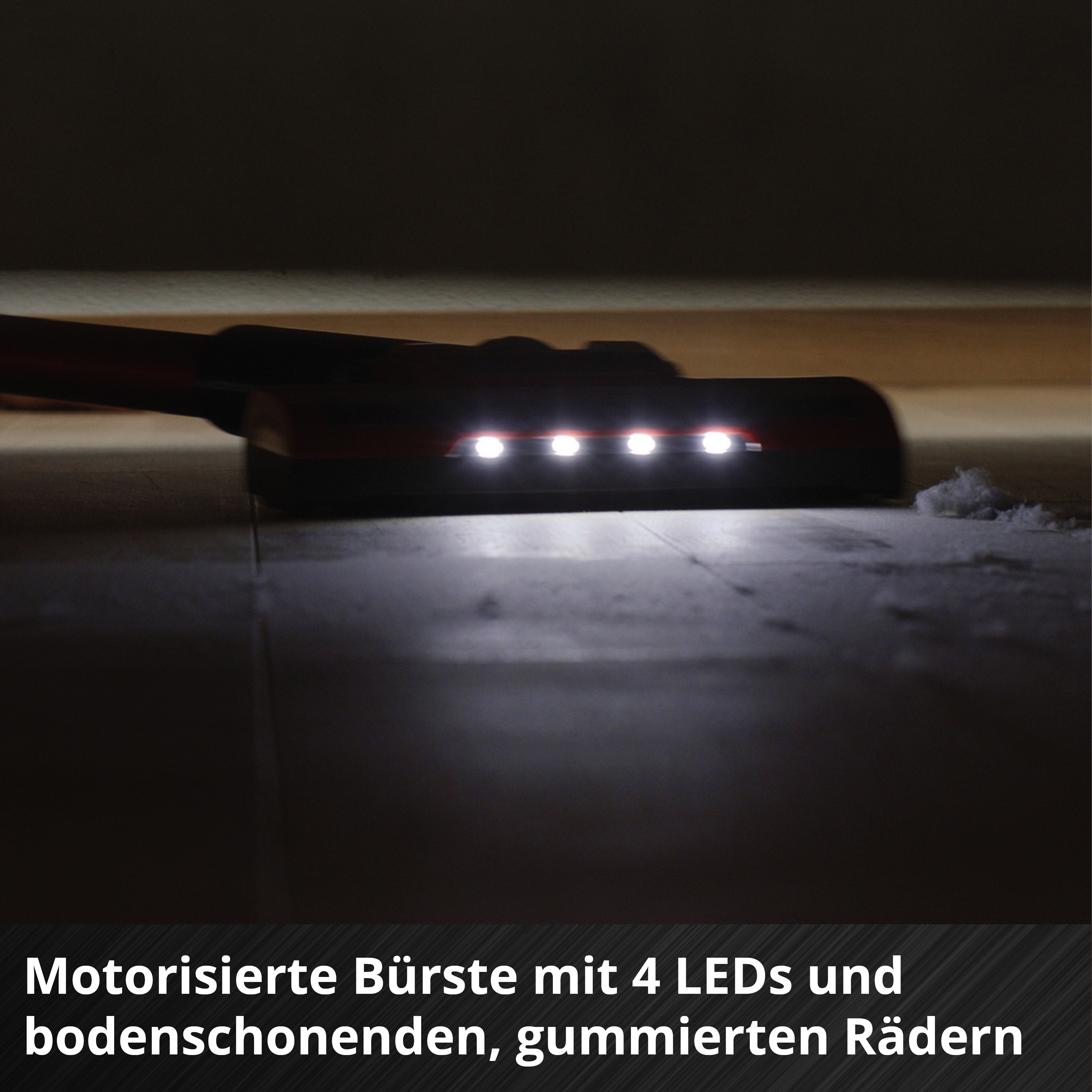 Bürstenkopf mit 4 LEDs leuchtet Staub auf dem Boden aus.