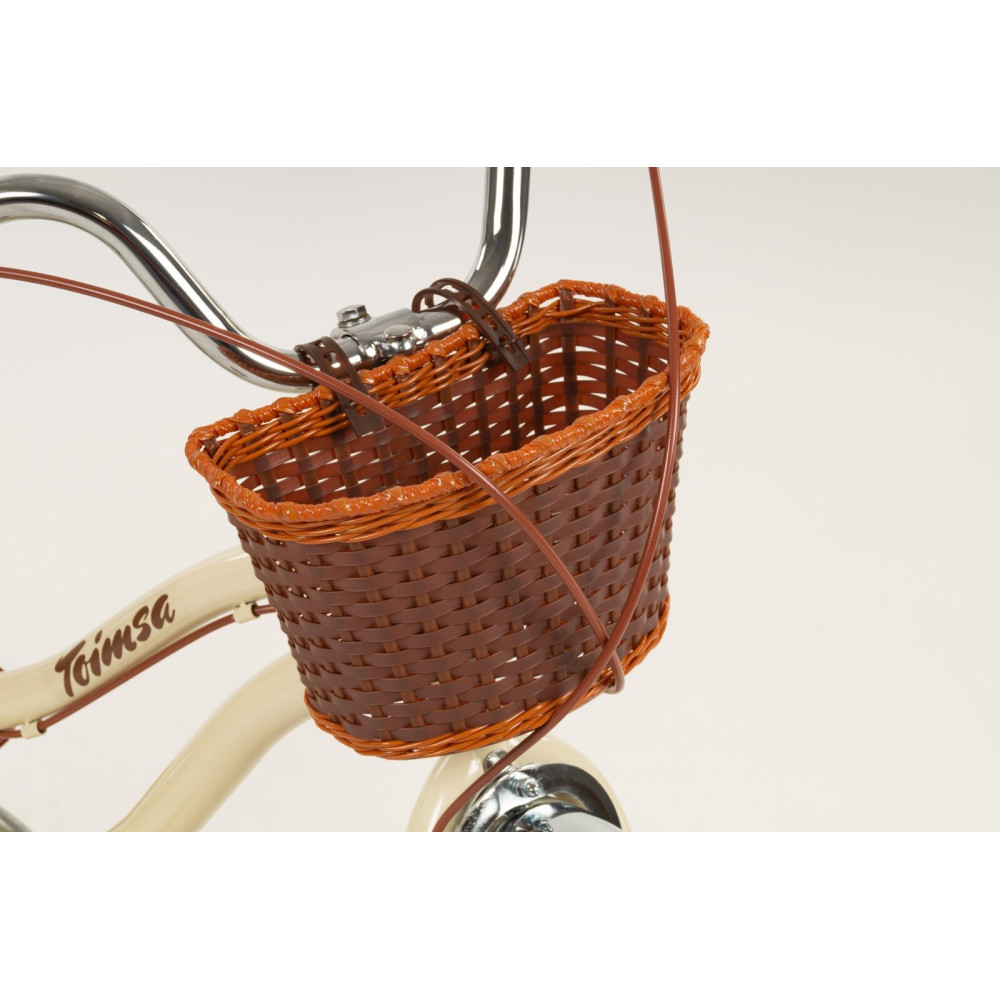 Kremowa rama roweru z brązowym koszykiem na kierownicy.