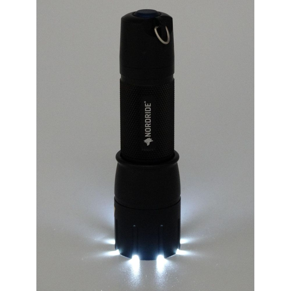 Lampe de poche noire avec logo NORDDRIDE et base éclairée.