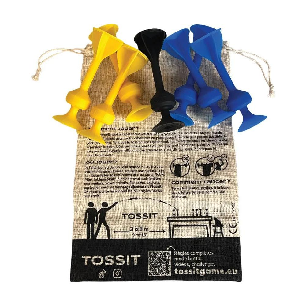 Gelbe, blaue und schwarze Tossit-Spielteile liegen auf einem Stoffbeutel.