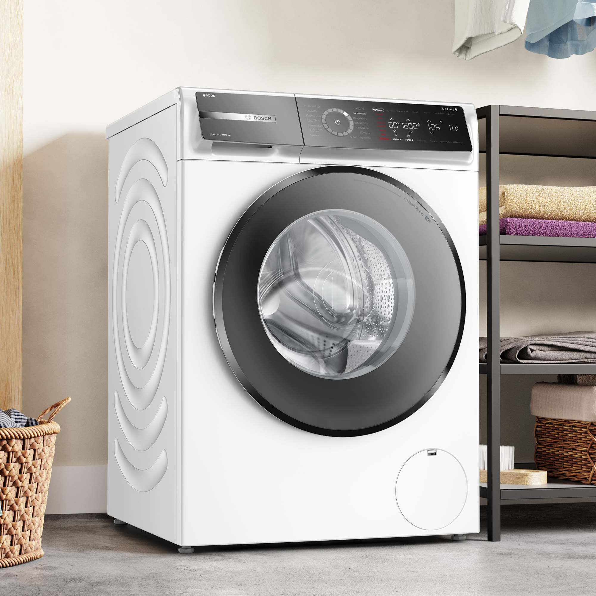 Eine weiße Bosch-Waschmaschine mit schwarzer Tür steht auf einem Betonboden.