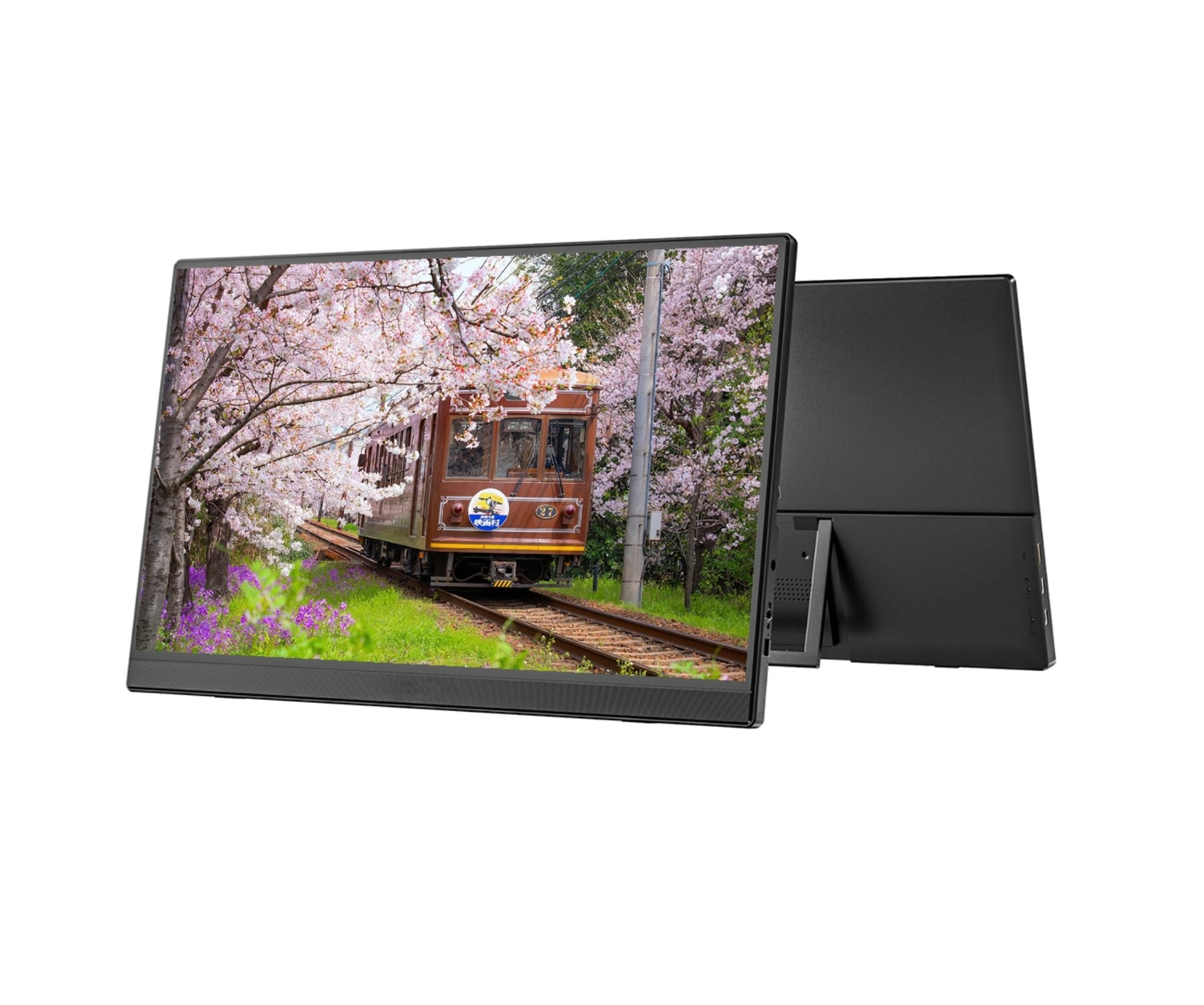 Un monitor muestra un tren en vías rodeado de cerezos en flor y flores moradas, con un soporte negro detrás.