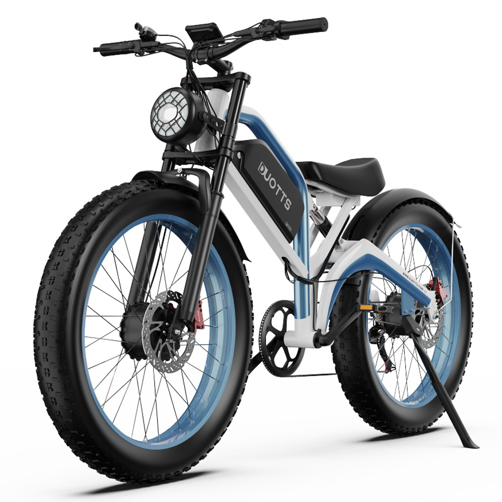 Una e-bike bianca e blu con pneumatici larghi e un faro rotondo.