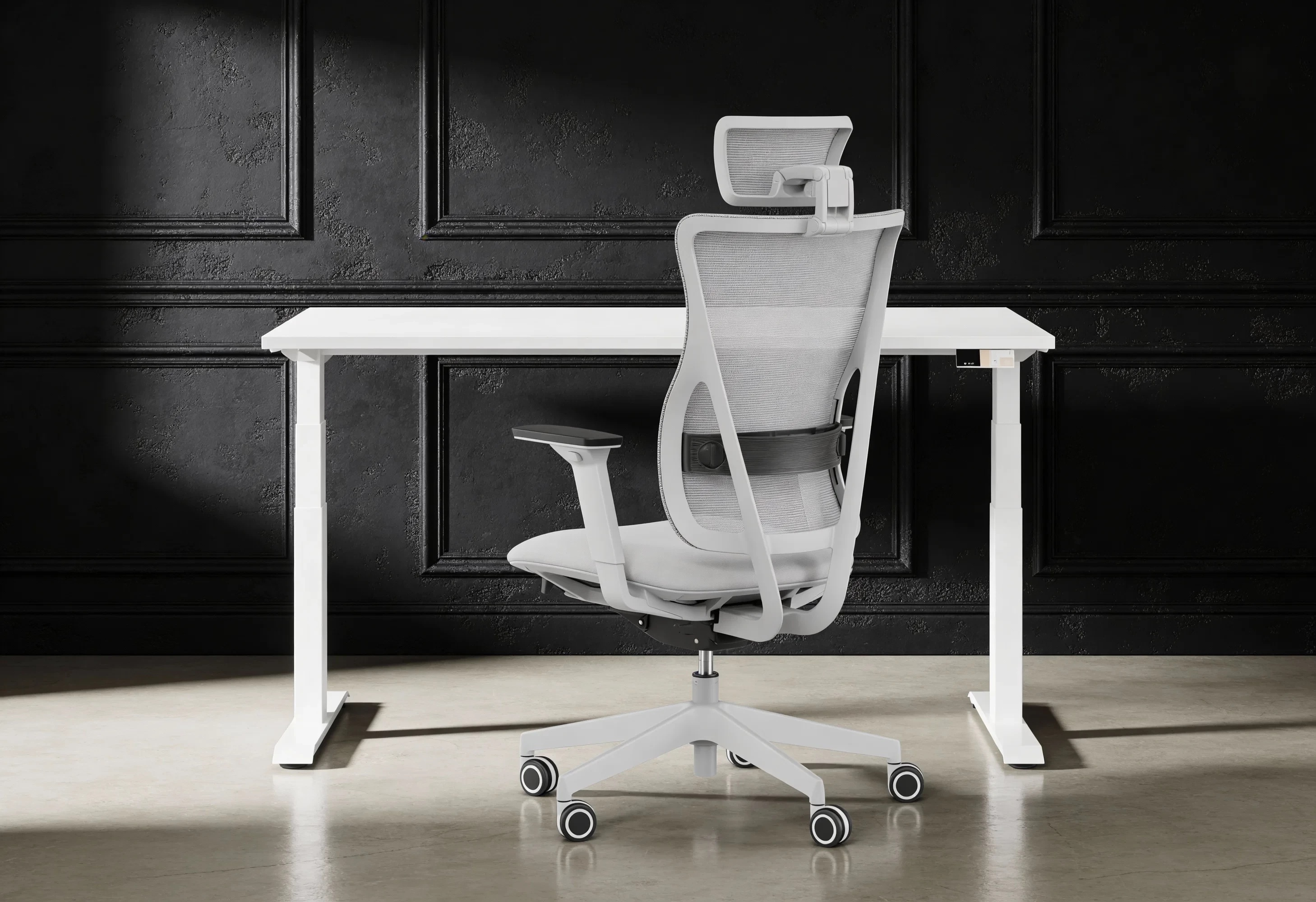 Białe biurko z białym fotelem biurowym z przodu, czarna ściana.