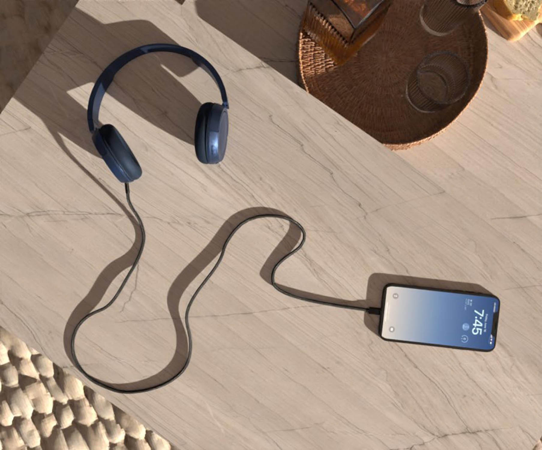 Blue headphones are connected by a cable to a smartphone.