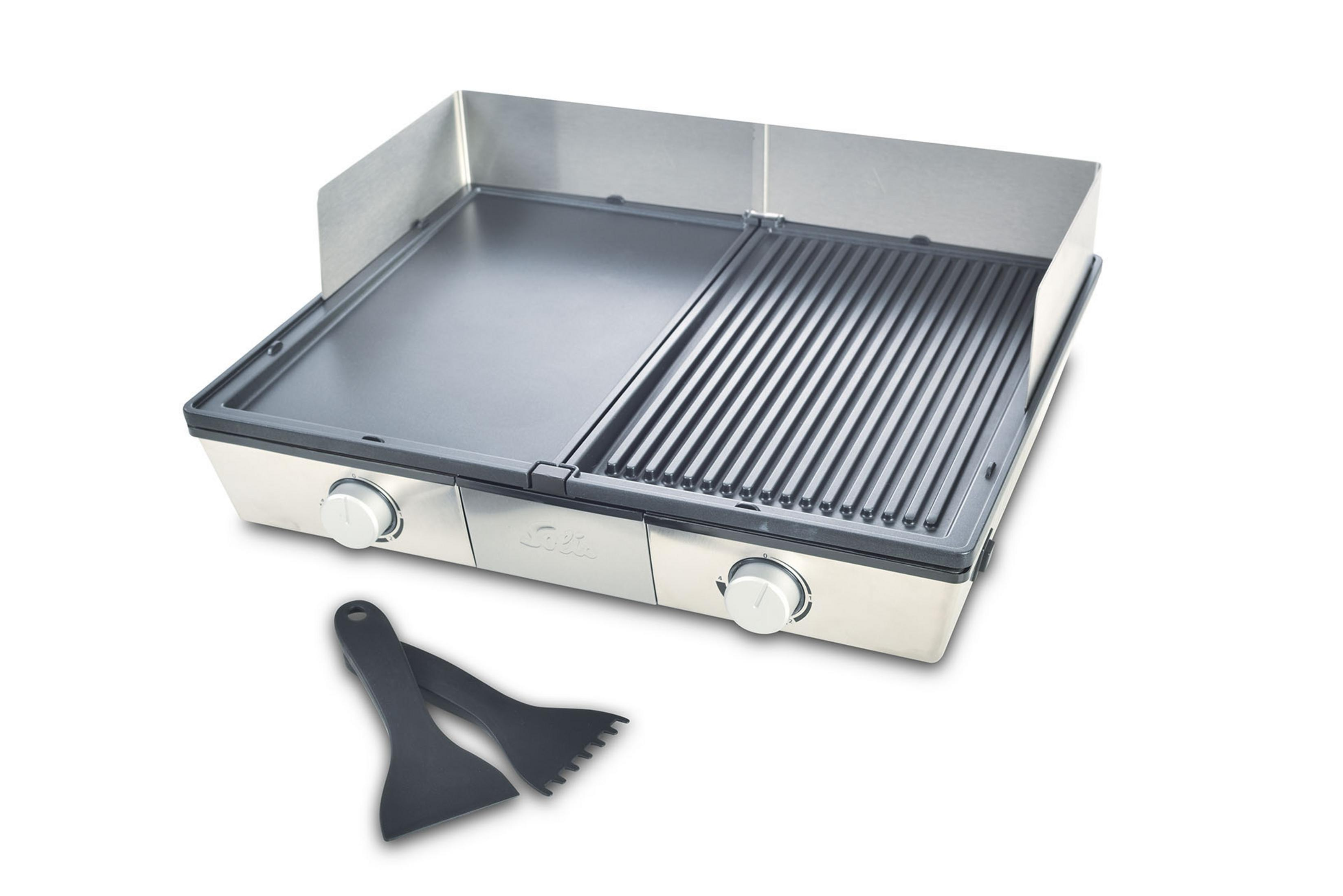 Een zilveren tafelgrill met twee kookoppervlakken en twee zwarte spatels.