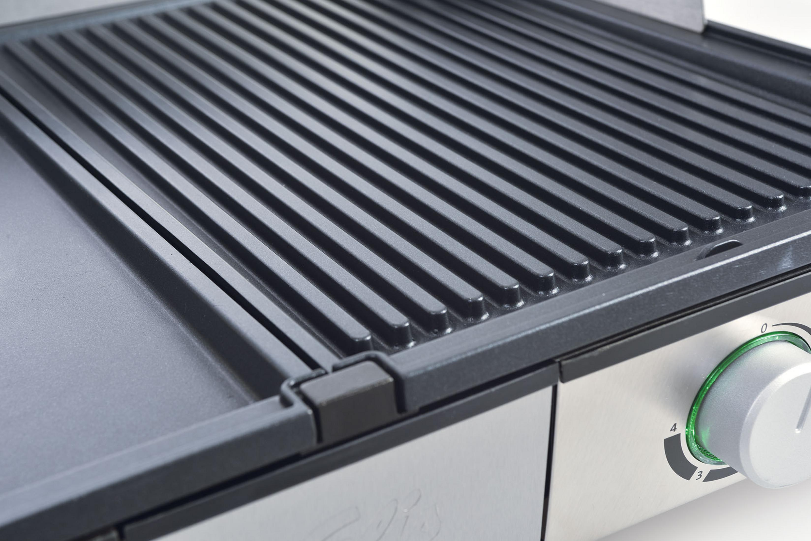 Close-up van een grillplaat met ribbels en een glad oppervlak.