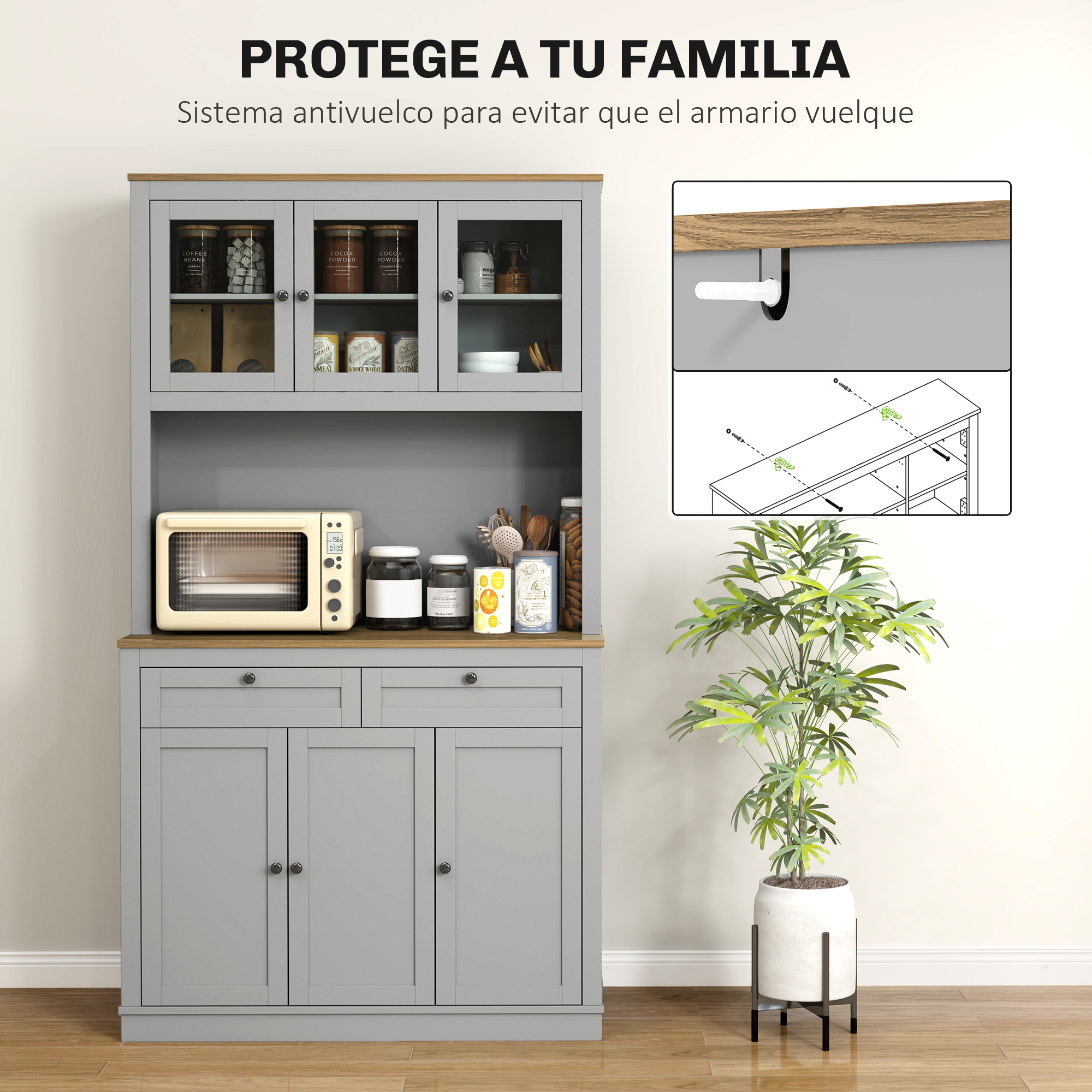 Aparador de cocina gris con puertas superiores de cristal, microondas, frascos y planta.