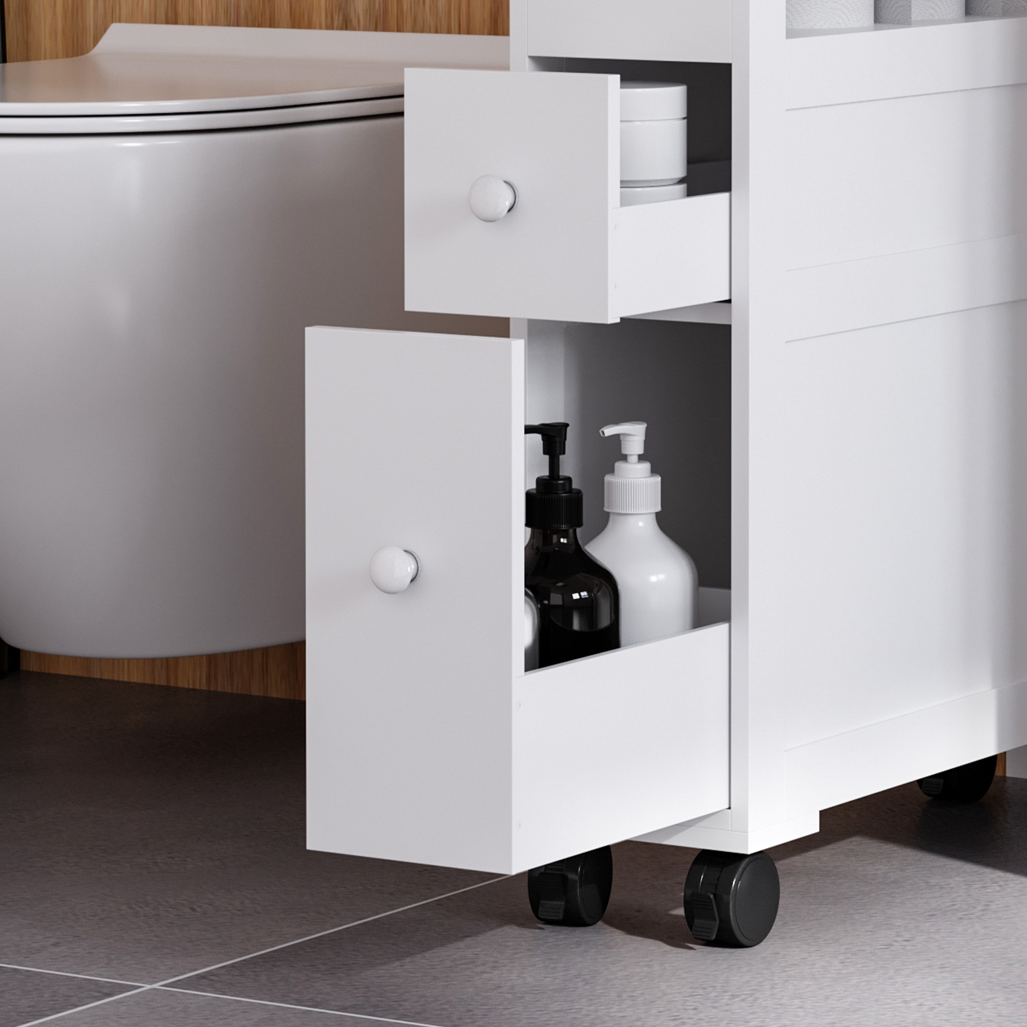 Un carrito de baño blanco con cajones abiertos que contienen jabones y cremas.