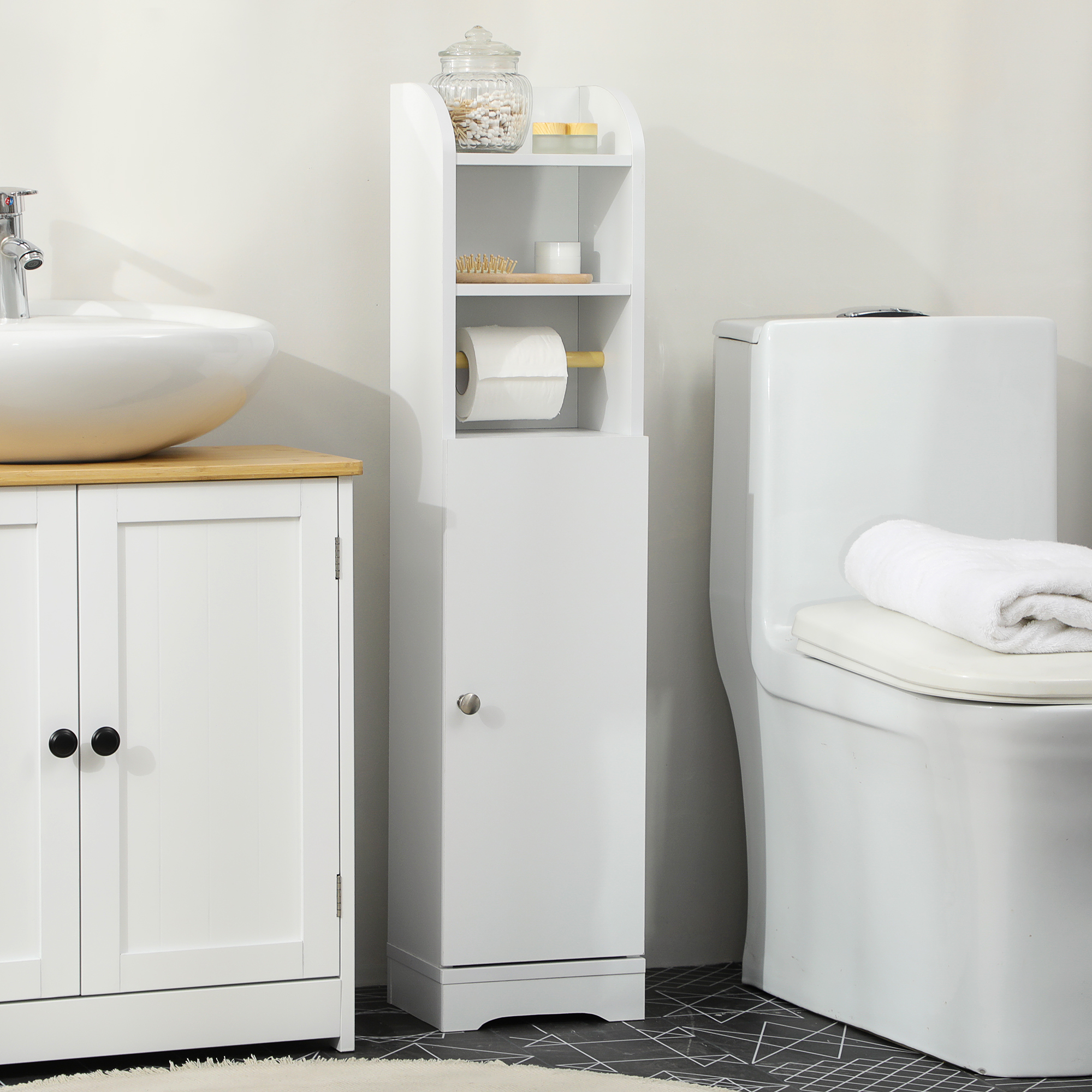 Un baño blanco con lavabo, mueble de almacenaje y váter.