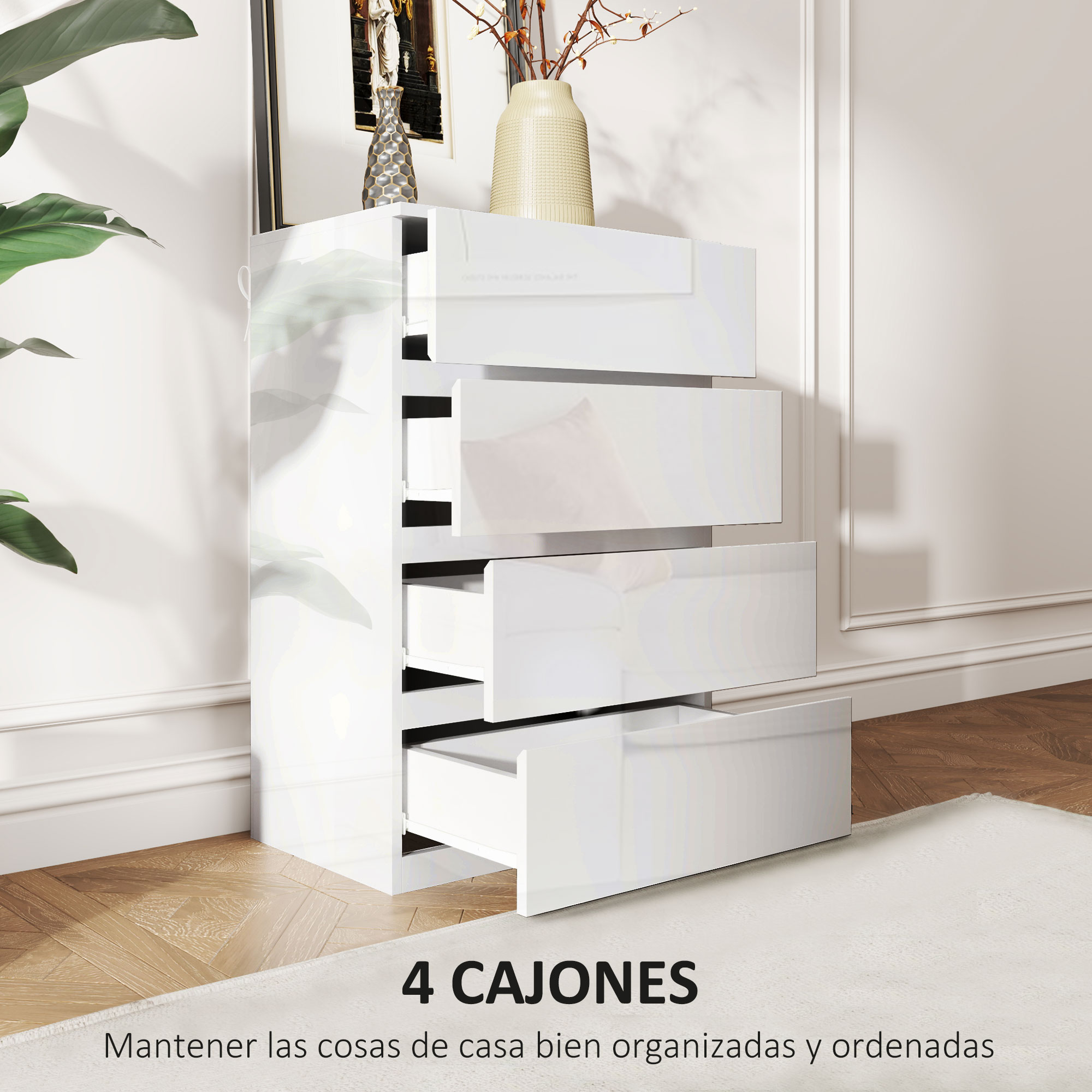 Cómoda blanca de cuatro cajones sobre suelo de madera.