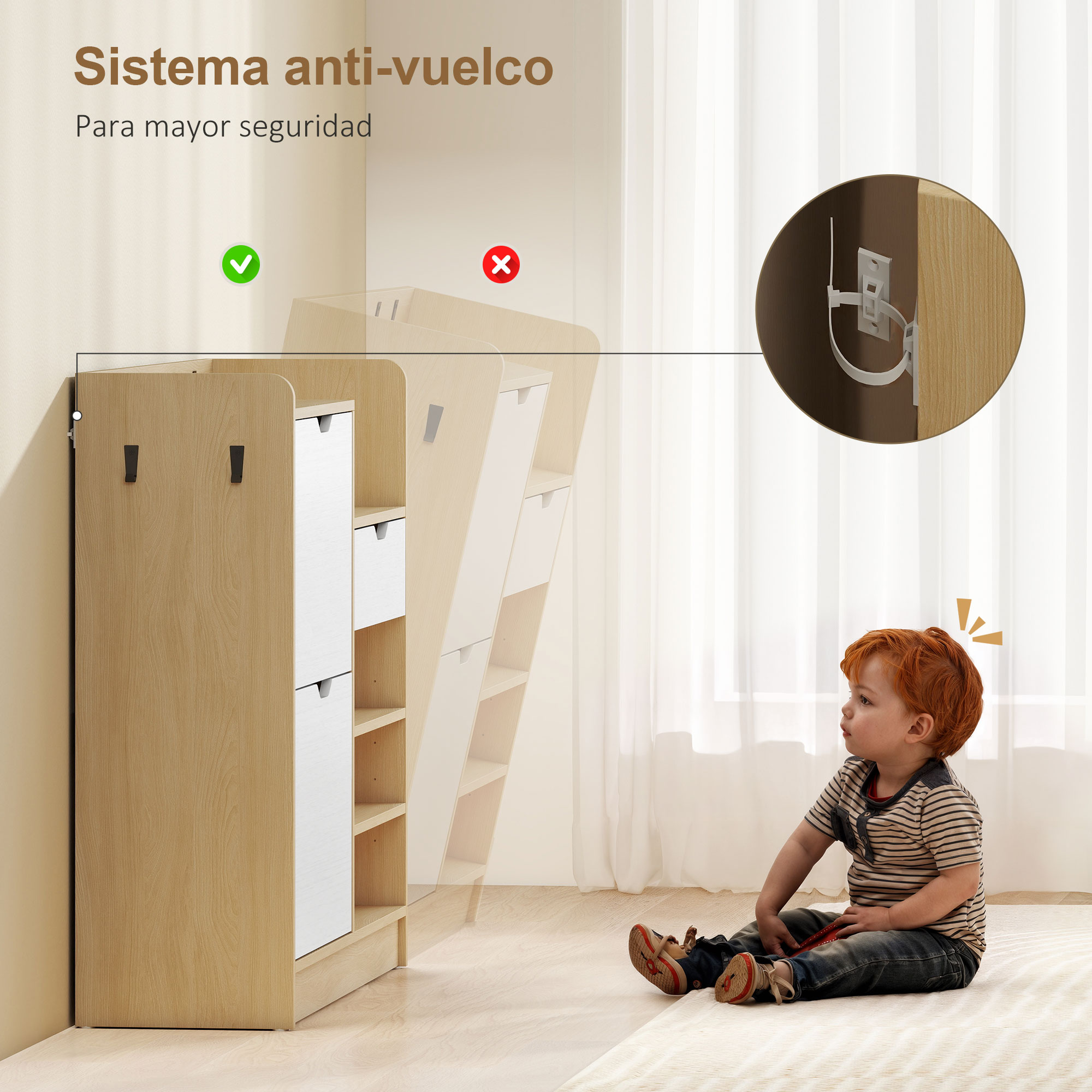 Un niño pequeño se sienta junto a un mueble de madera con cajones blancos. Se muestra un sistema antivuelco.