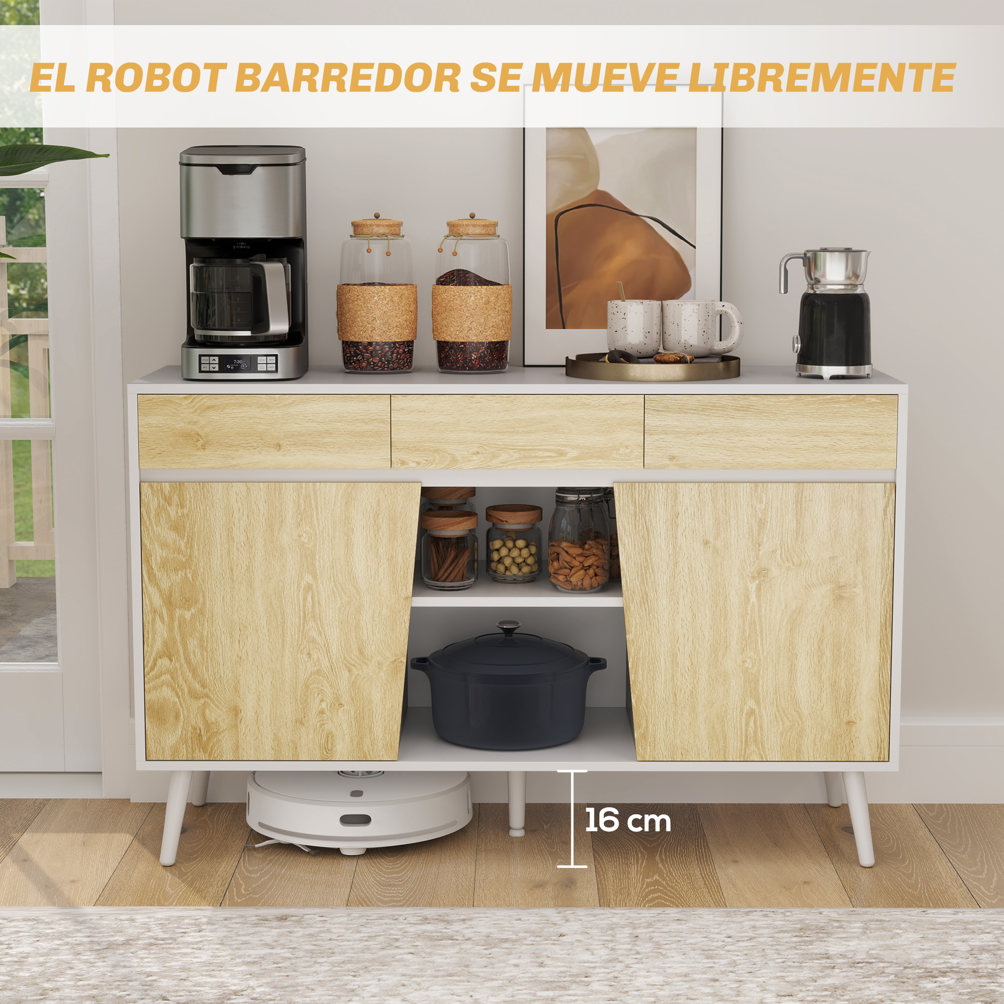 Un robot aspirador blanco limpia el suelo bajo un aparador blanco con frentes de madera.