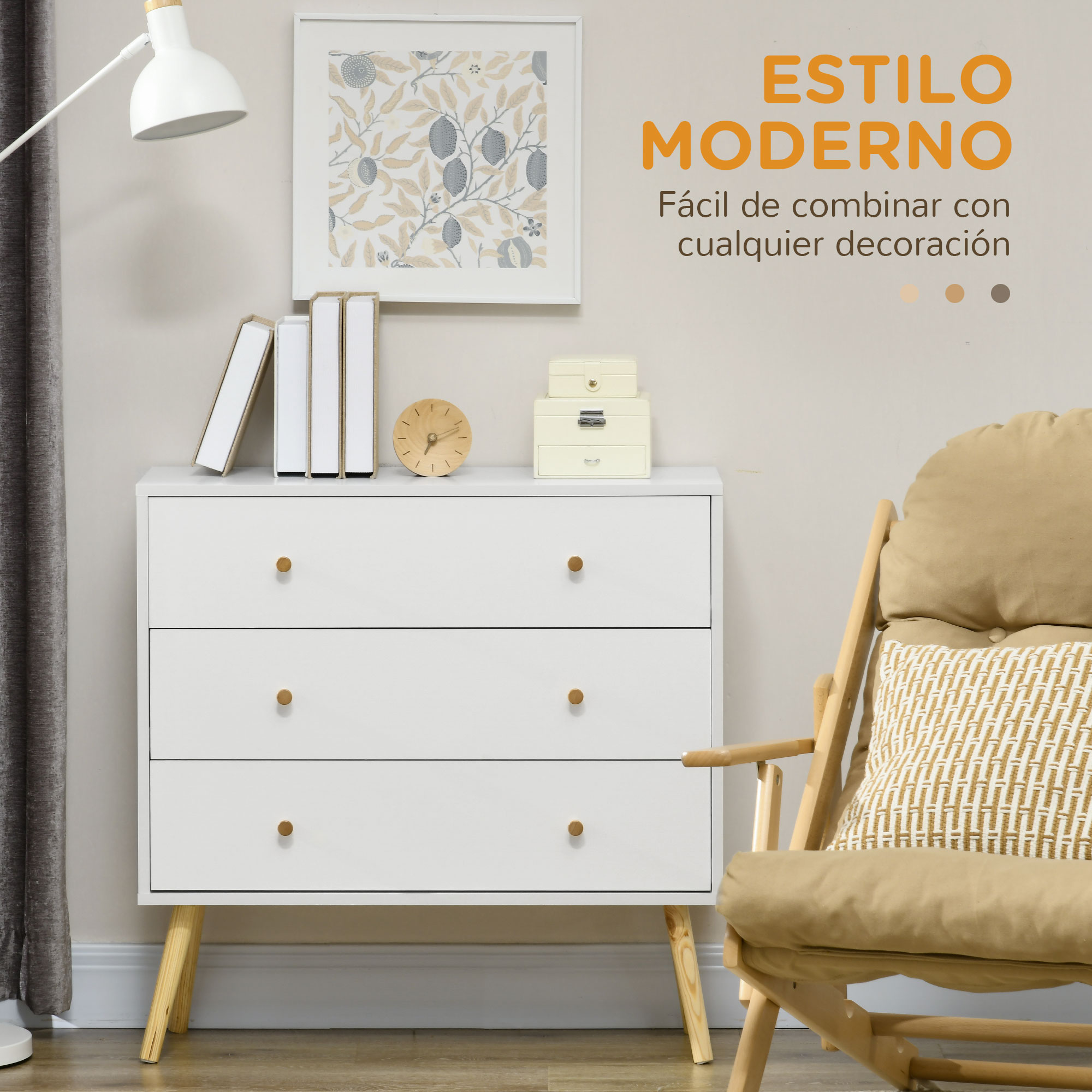 Una cómoda blanca con patas de madera, libros, reloj y decoración.