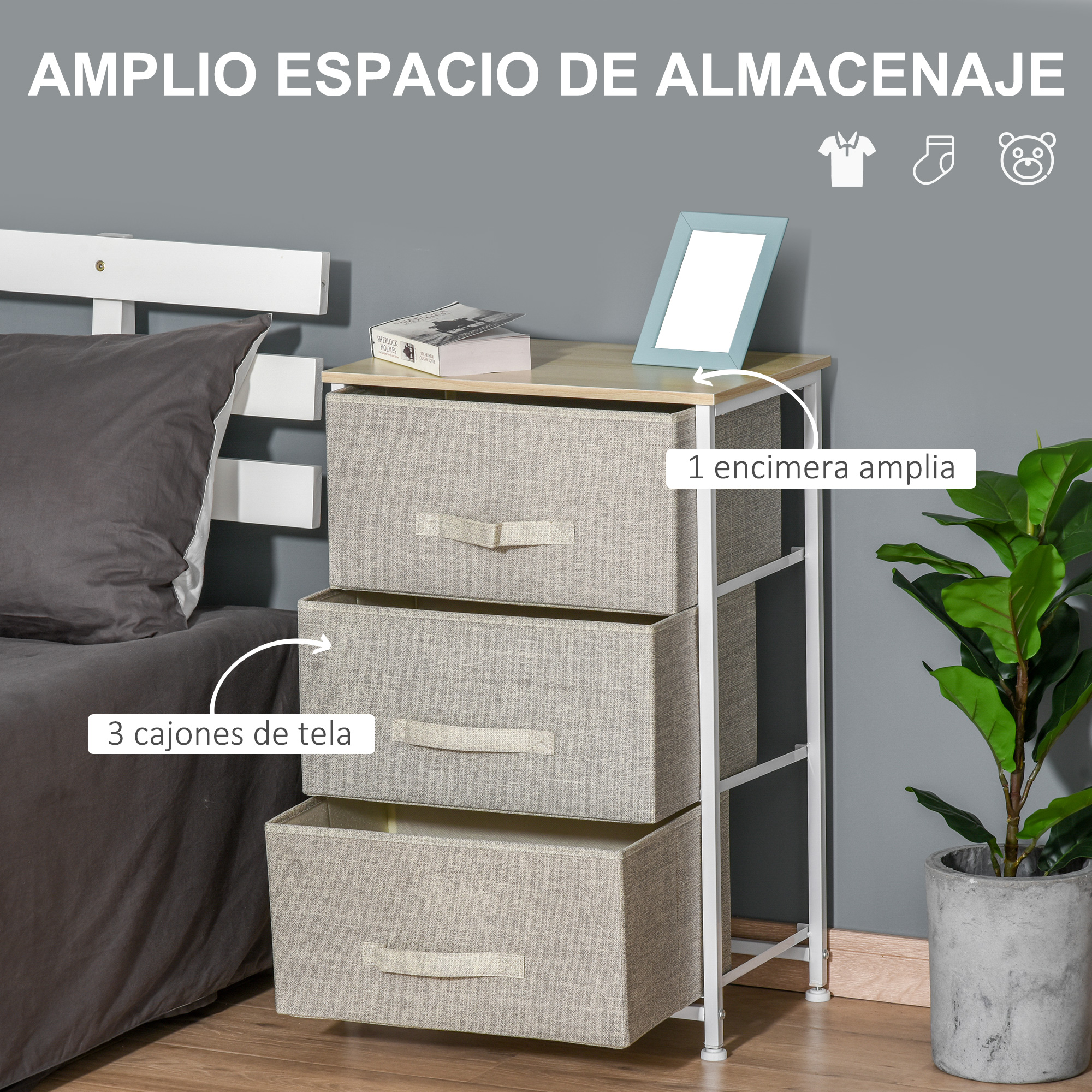 Un tocador de tela con tres cajones junto a una cama y una planta.