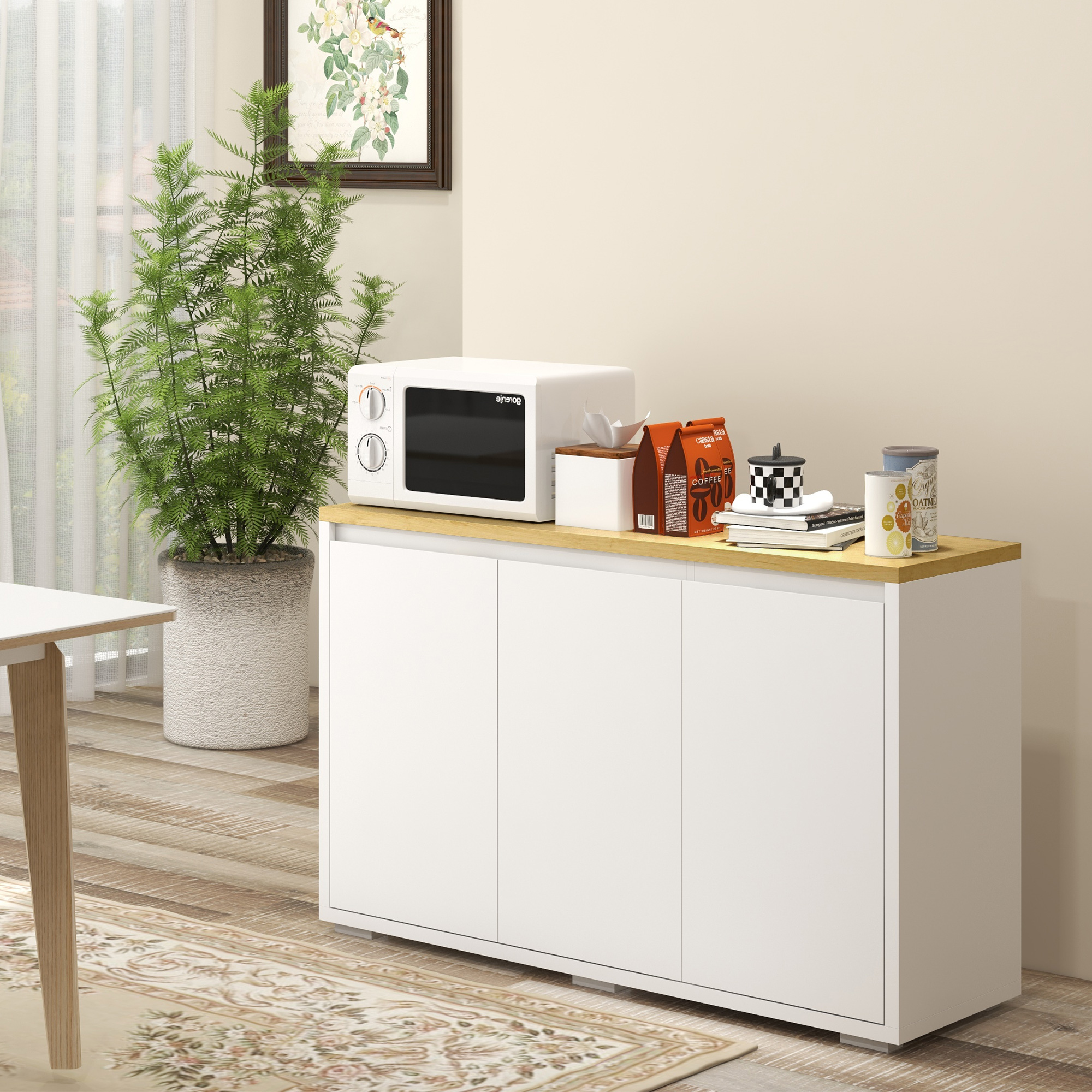 Un armario blanco con tapa de madera, con microondas y paquetes de café encima.