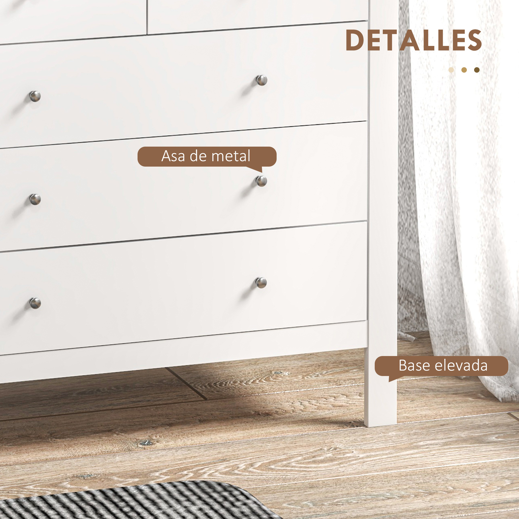 Detalle de tocador blanco con tiradores plateados sobre suelo de madera.