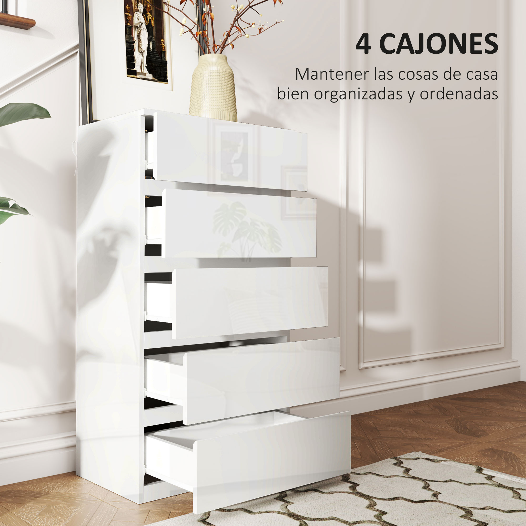 Una cómoda blanca con cuatro cajones abiertos está sobre un suelo de madera.