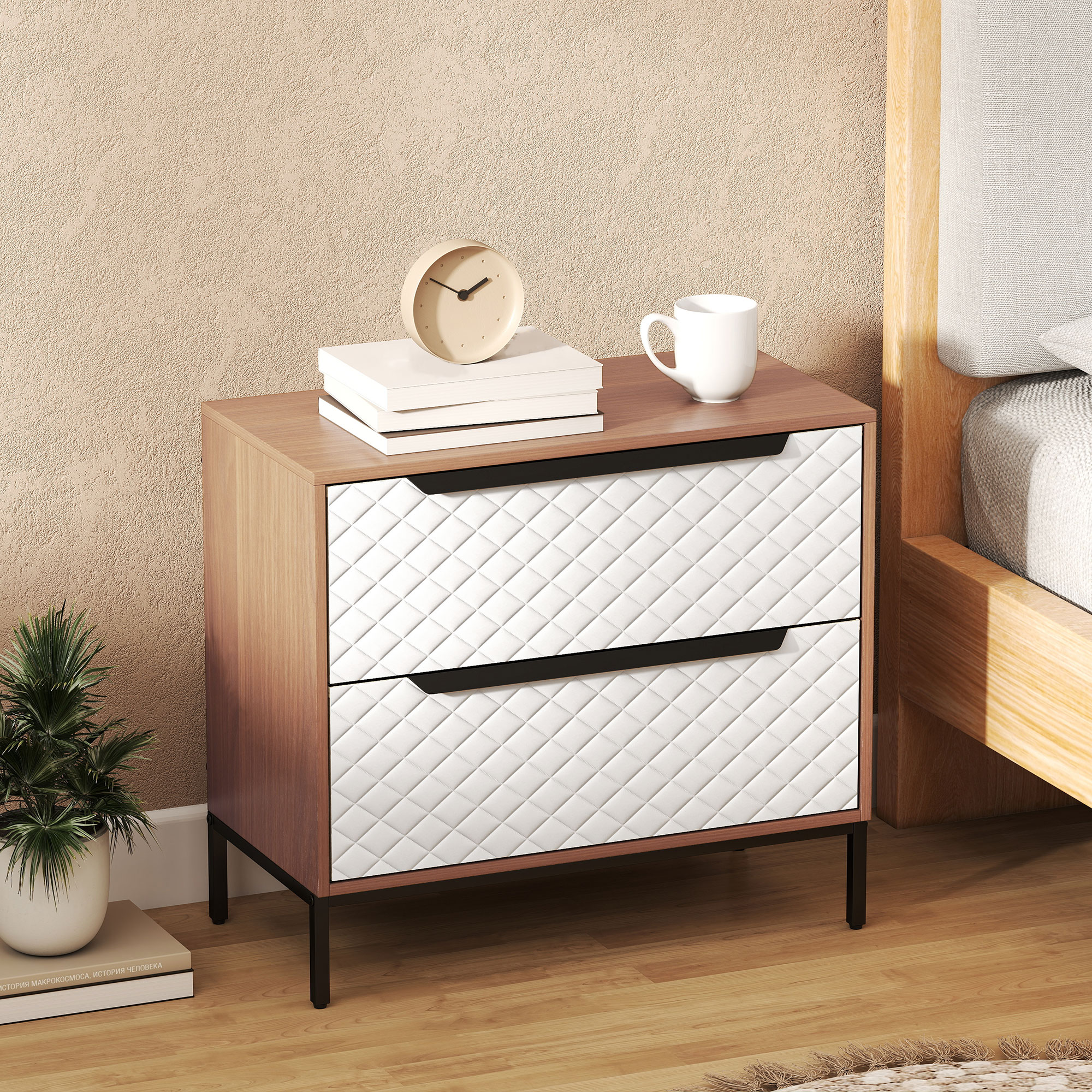 Una mesita de noche de madera con cajones blancos junto a una cama.