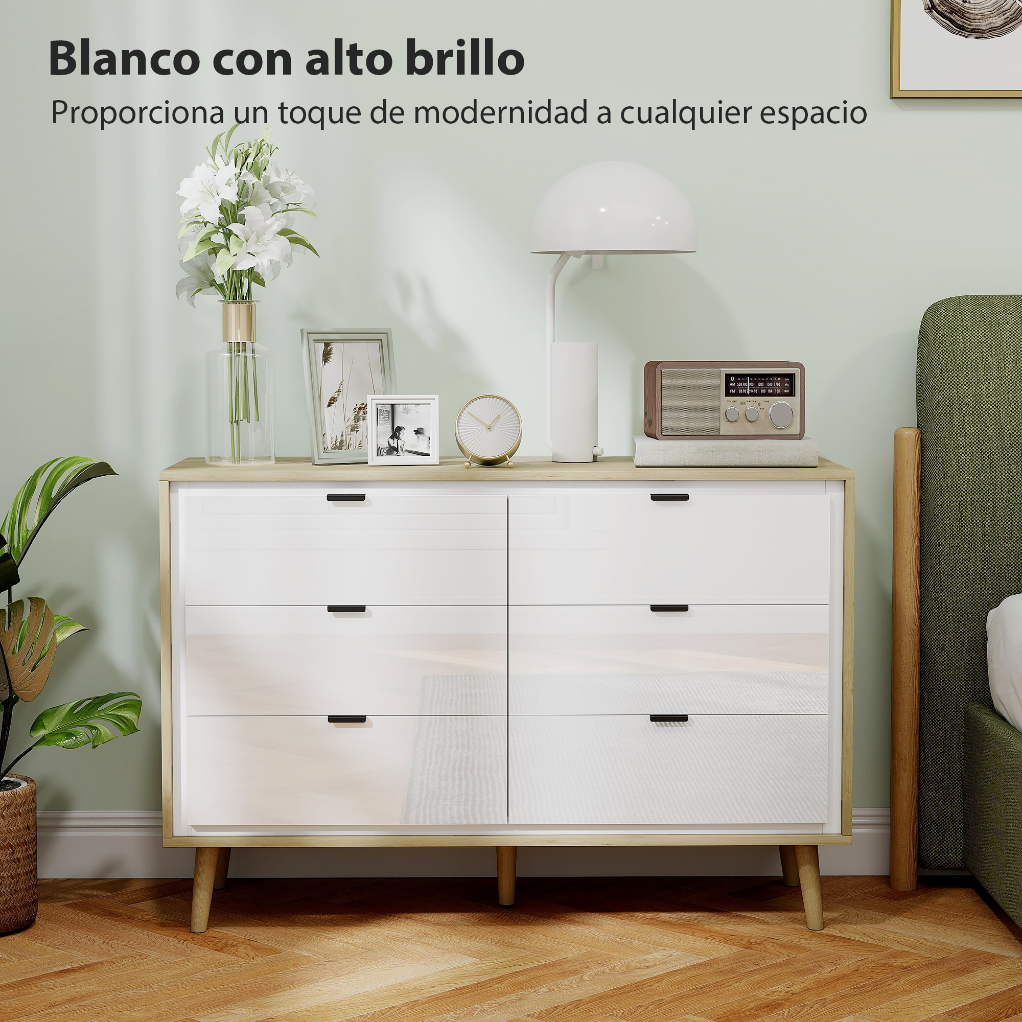 Cómoda blanca de seis cajones, decorada con jarrón, cuadros y lámpara.