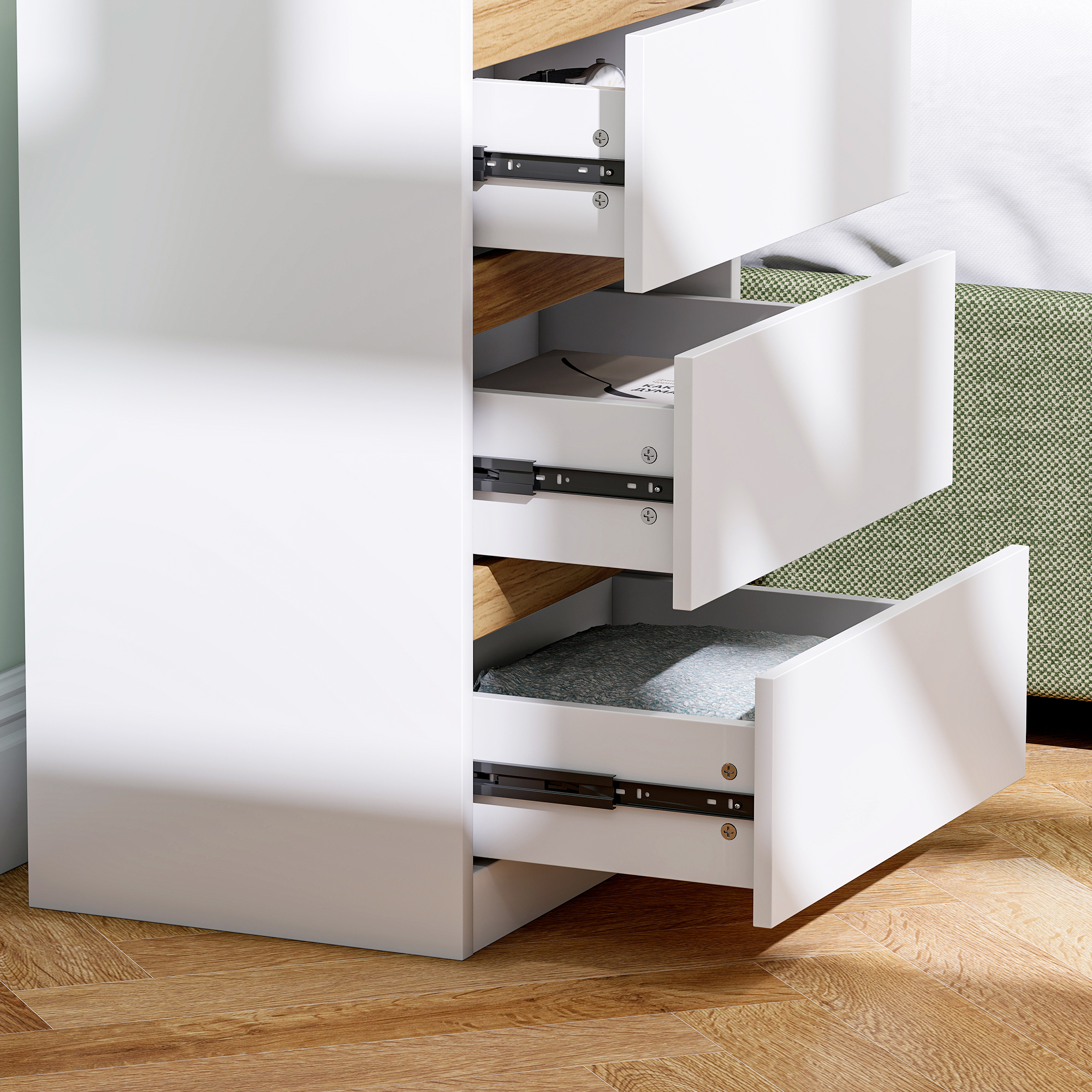 Cómoda blanca con cajones abiertos sobre suelo de madera.