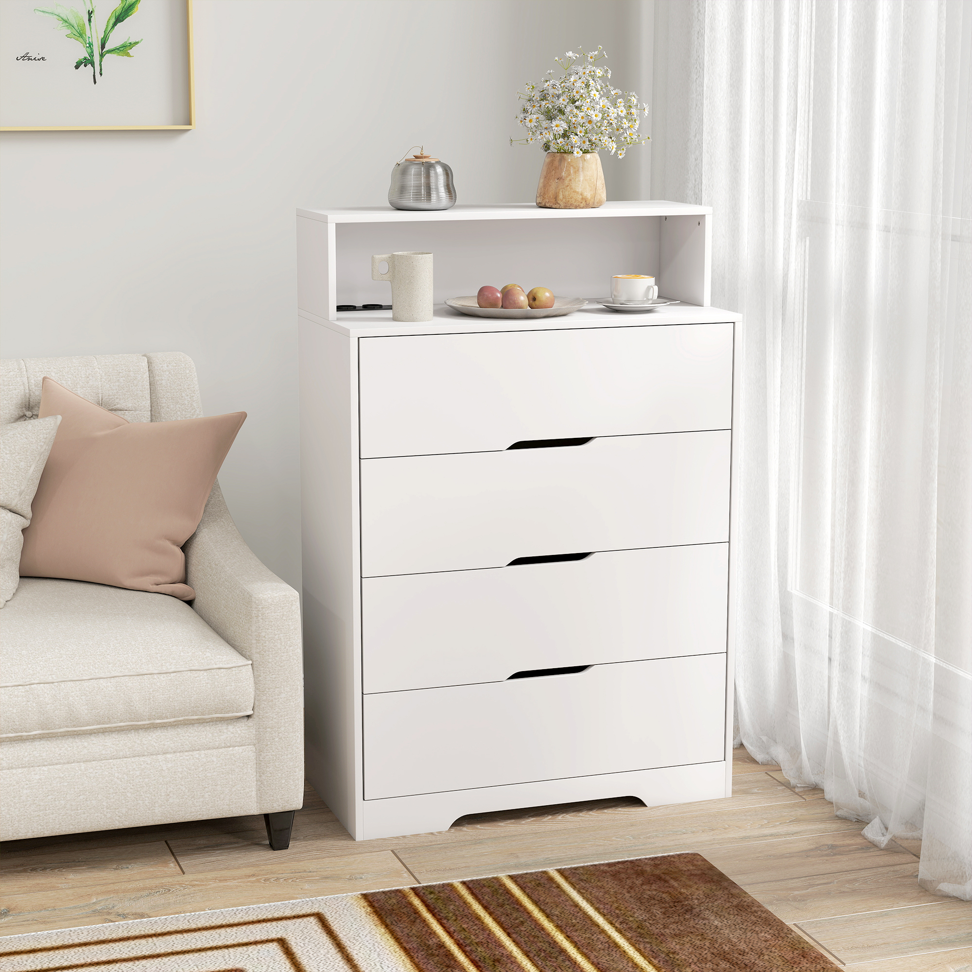 Cómoda blanca de cuatro cajones junto a un sillón crema con cojines.