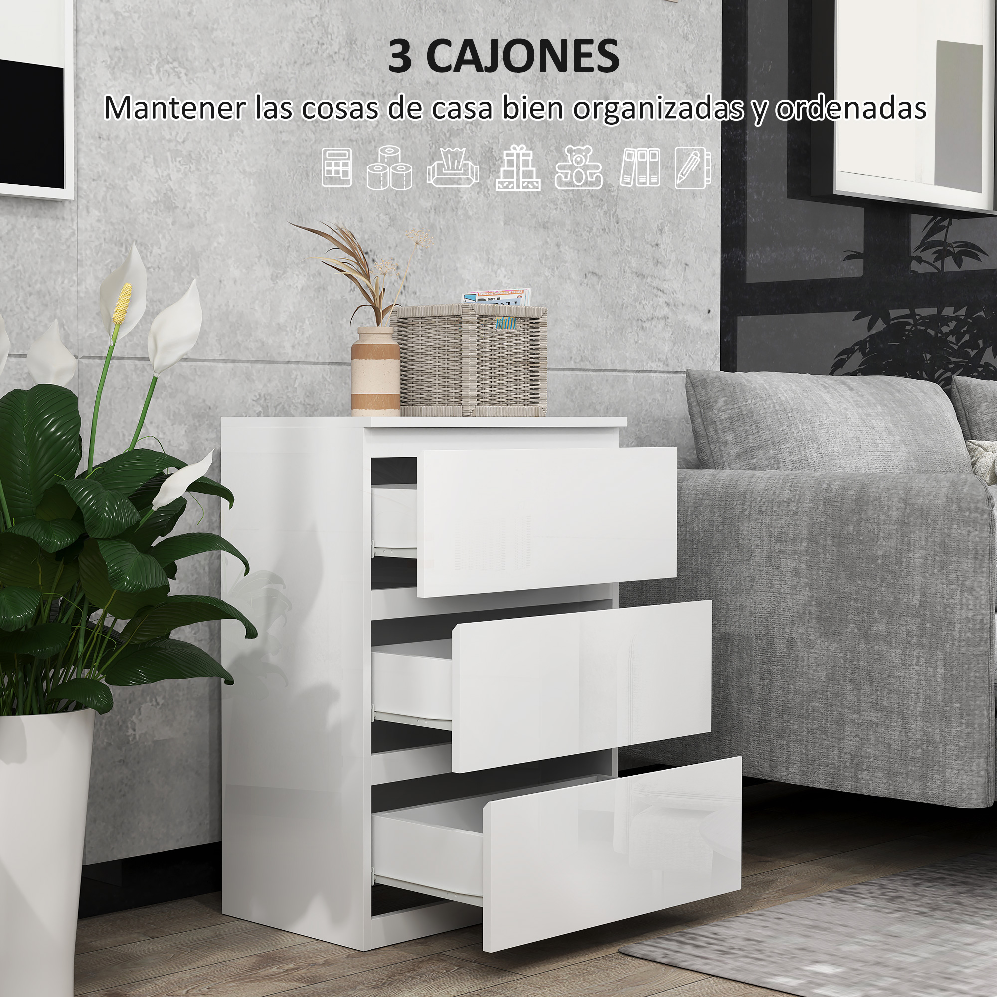 Una mesita de noche blanca con tres cajones abiertos junto a un sofá.