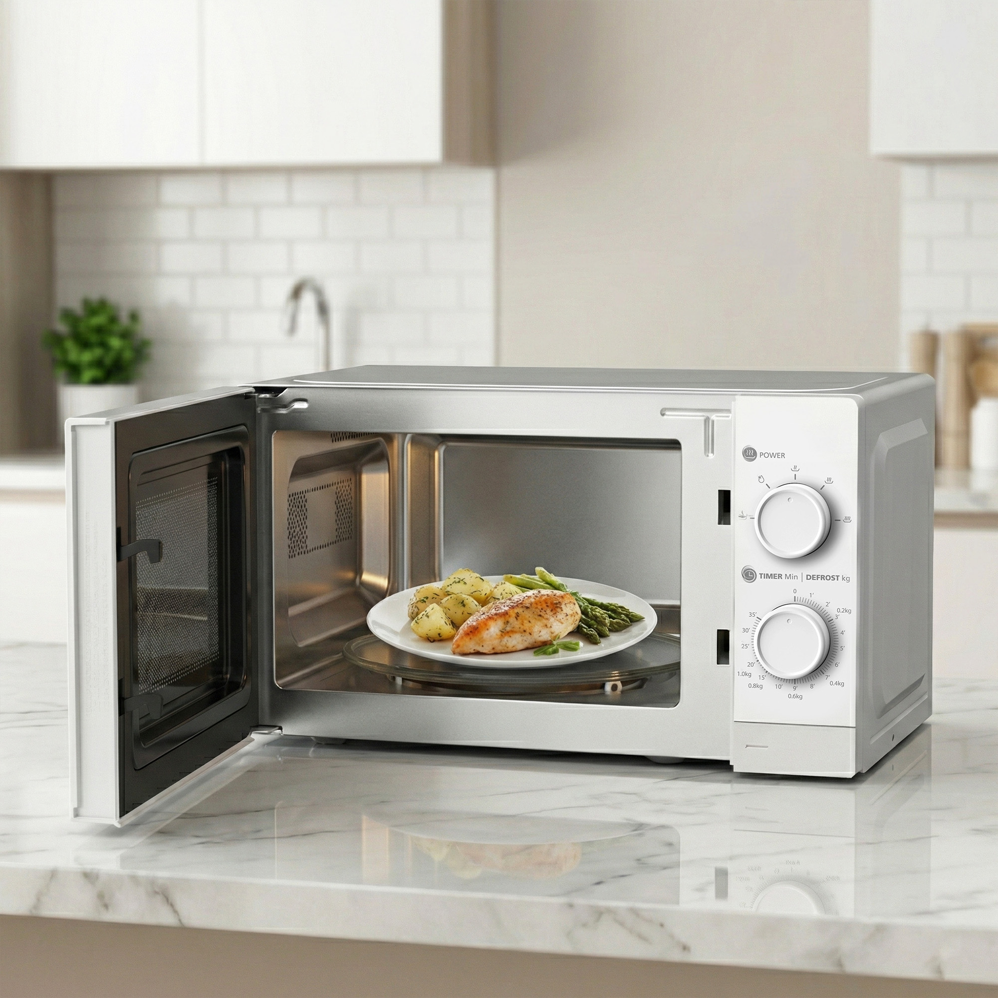 An open microwave with a plate of chicken, potatoes, and asparagus inside.