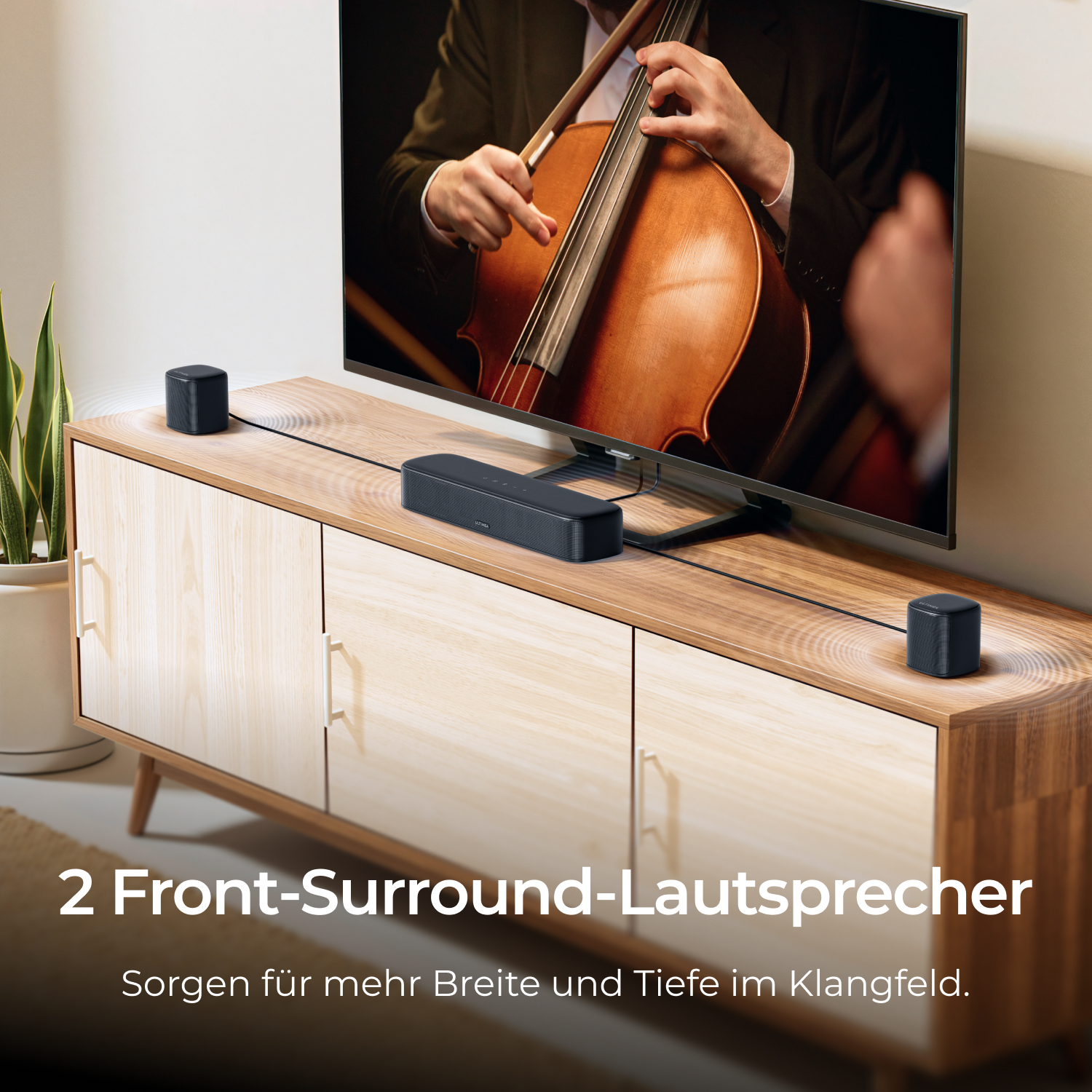 Twee zwarte luidsprekers op een houten kast voor een tv.