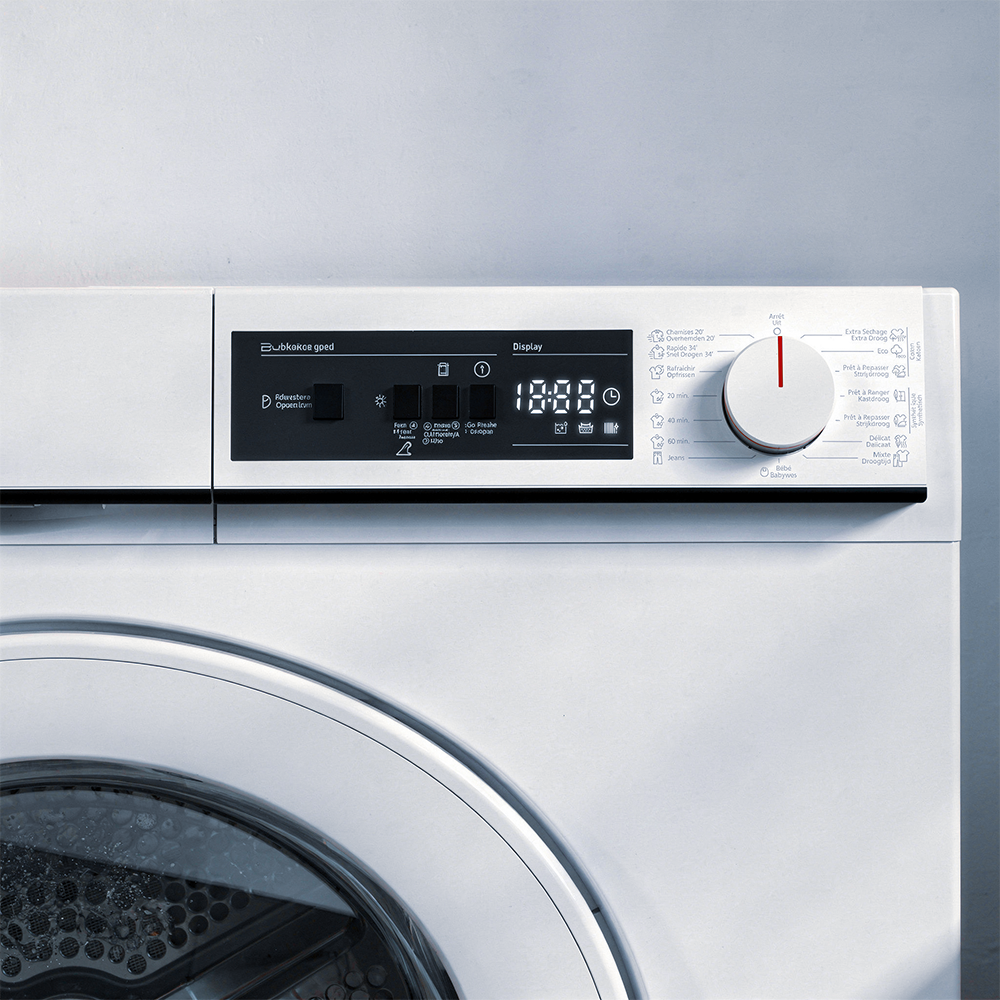 Close-up of a white washing machine control panel with display and dial.