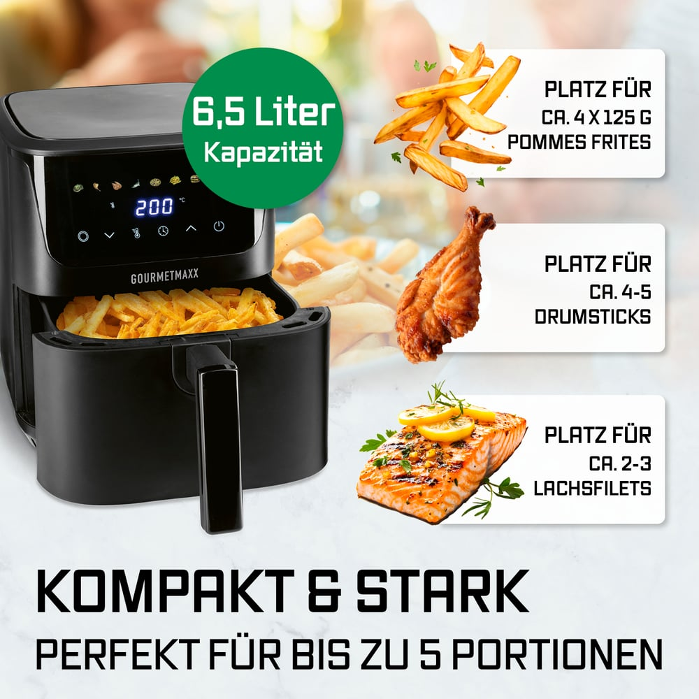 Schwarzer Heißluftfritteuse mit Pommes, Hähnchenschenkeln und Lachs.