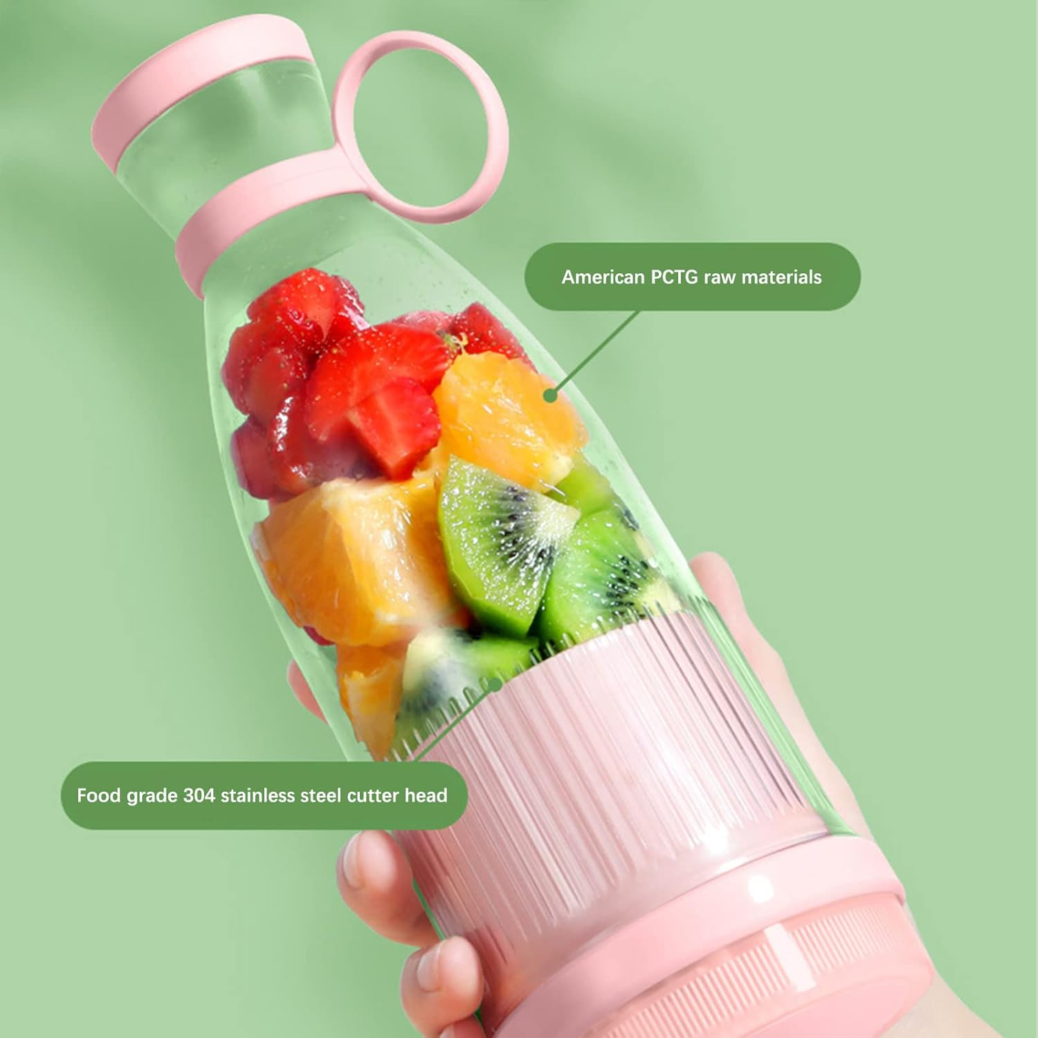 Eine Hand hält einen rosa-transparenten tragbaren Mixer, gefüllt mit gehackten Erdbeeren, Orangen und Kiwi.