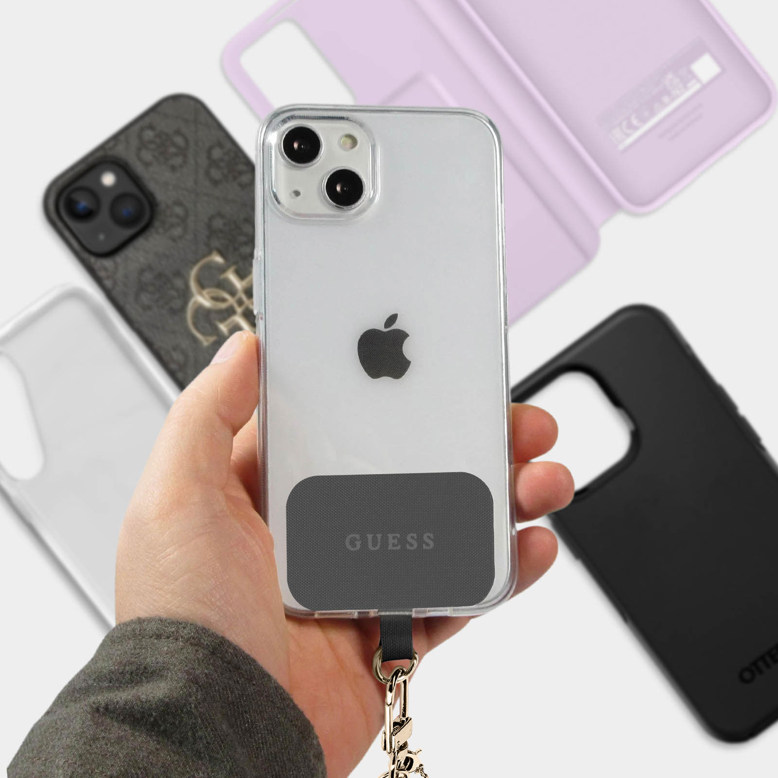 iPhone mit durchsichtigem Gehäuse, GUESS-Aufkleber, Lanyard und anderen Hüllen.
