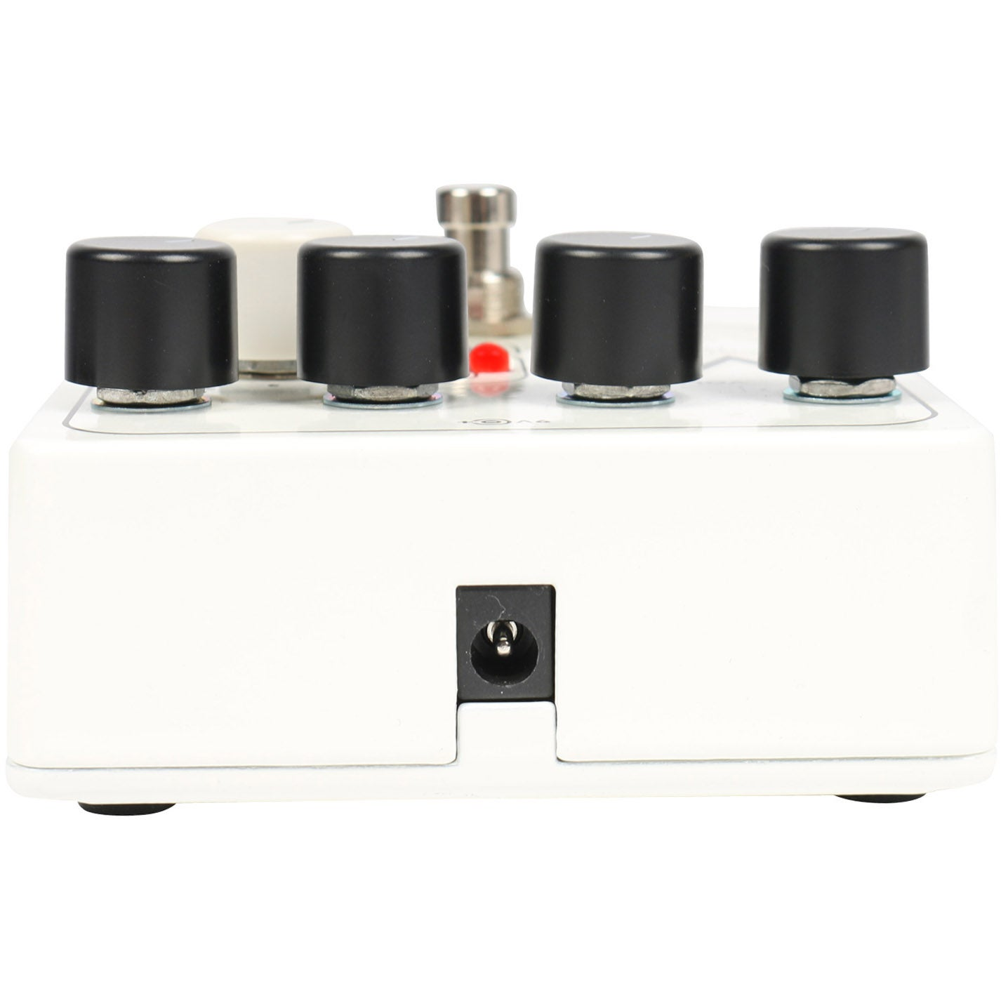 White pedal unit with four black knobs and a power connector on the side.
