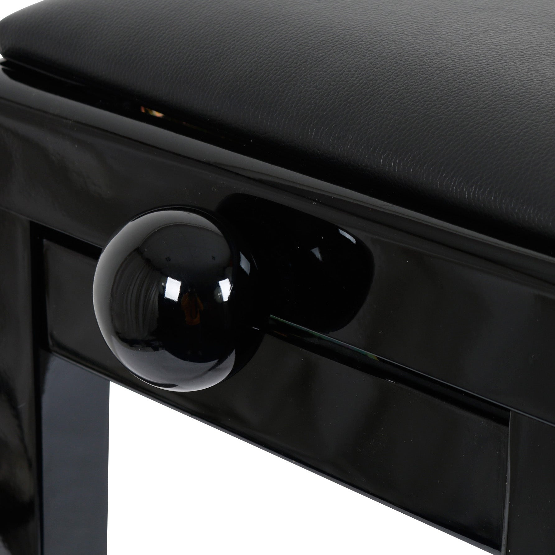 Black piano bench with glossy accents and leather upholstery.