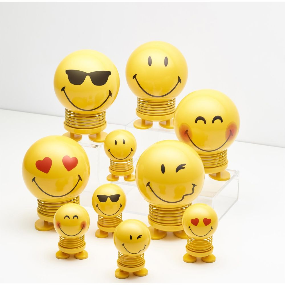 Un gruppo di otto figure gialle smiley su molle con varie espressioni.
