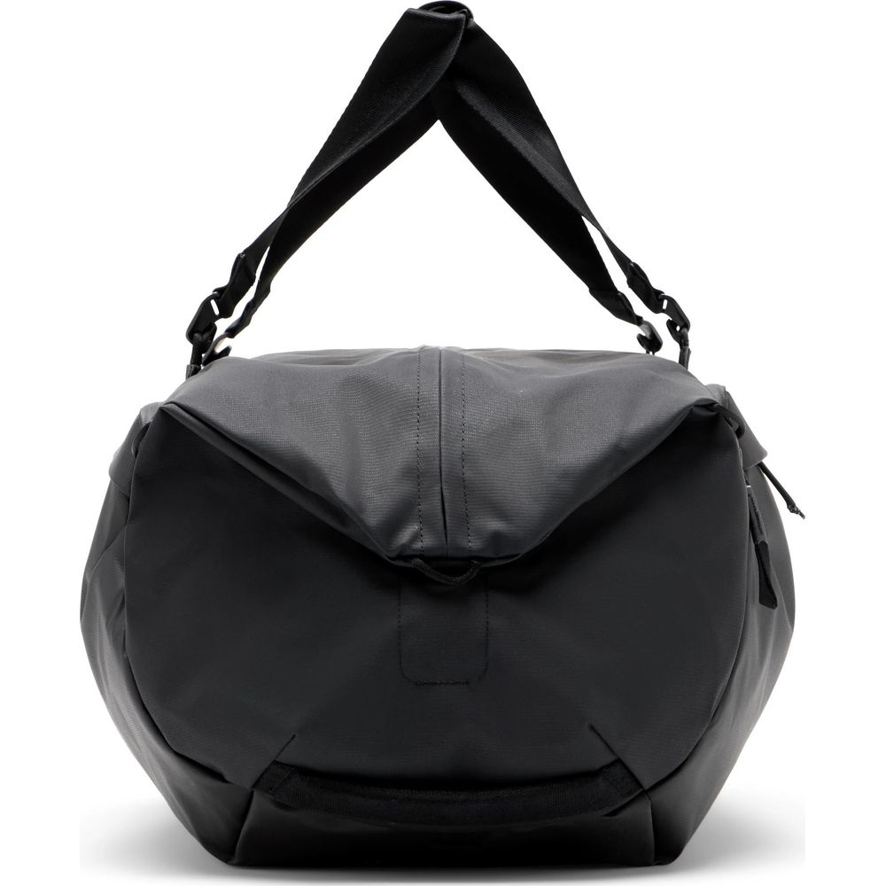 Black duffel bag with handles and adjustable strap, isolated on a white background.