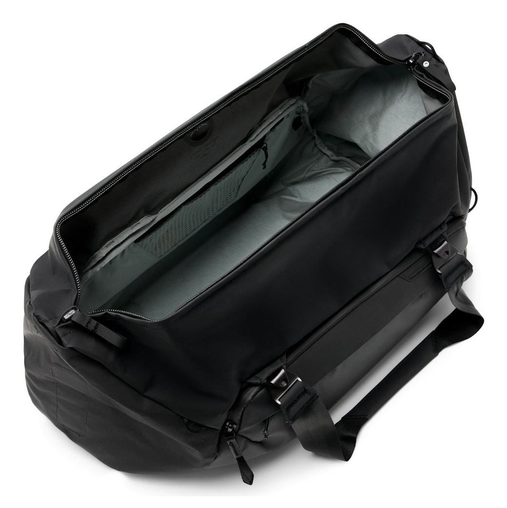 Black duffel bag with an open main compartment and interior pockets.