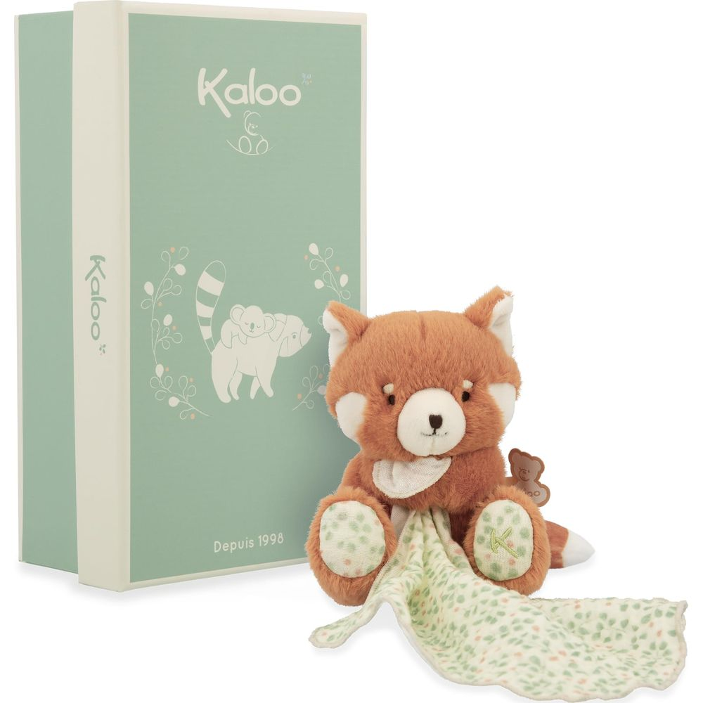 Un peluche panda rosso siede accanto a una scatola verde menta con logo Kaloo e grafiche di animali.