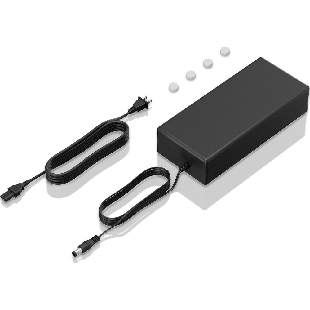 Adaptateur secteur noir pour ordinateur portable avec deux câbles et quatre capuchons blancs.