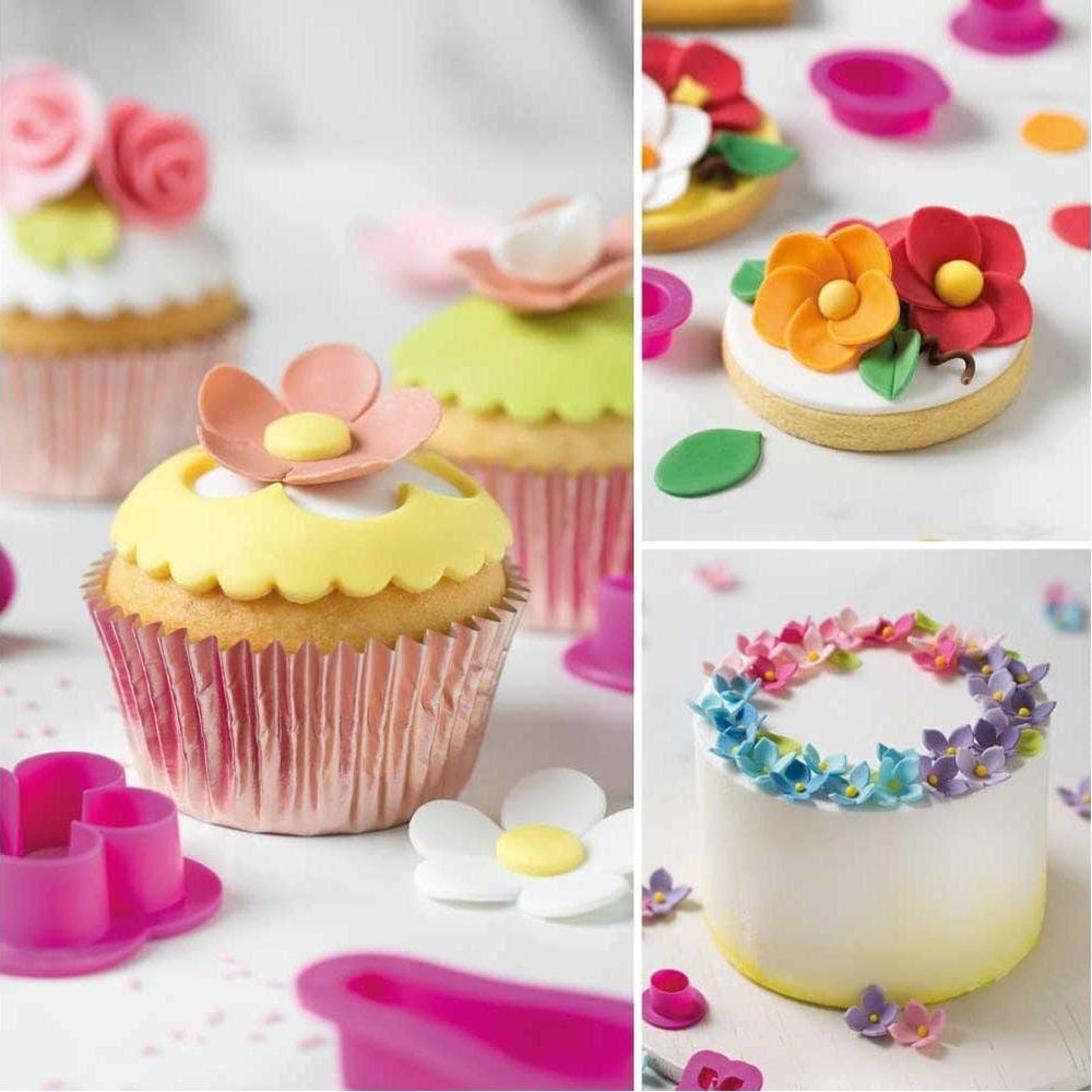 Bunte Cupcakes, Kekse und ein kleiner Kuchen mit Blumen-Dekorationen.