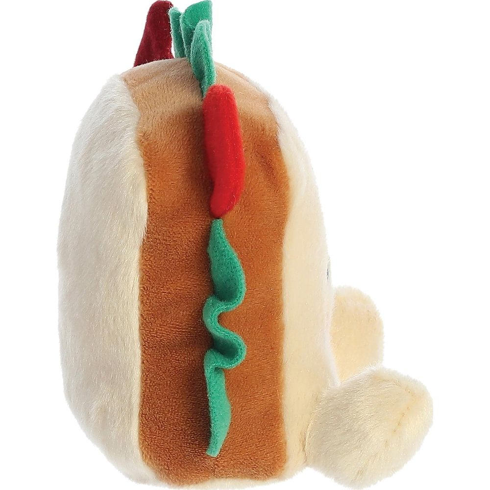 Un giocattolo hot dog di peluche con dettagli di peperoncino rosso e lattuga verde.