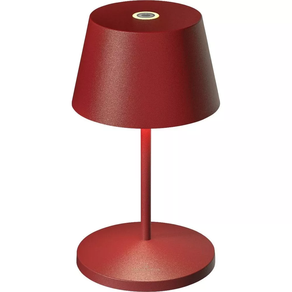 Una lampada da tavolo rossa con base rotonda e paralume conico.