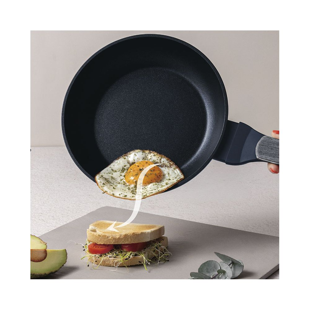 Œuf au plat glissant de la poêle sur sandwich à l'avocat.