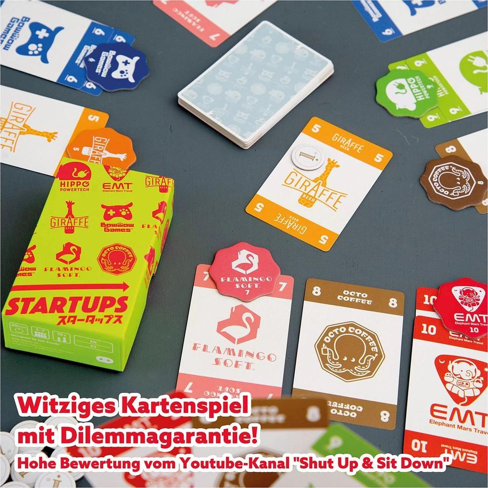 Brettspiel mit Karten: Giraffe, Flamingo, Octopus und EMT-Designs auf dem Tisch.